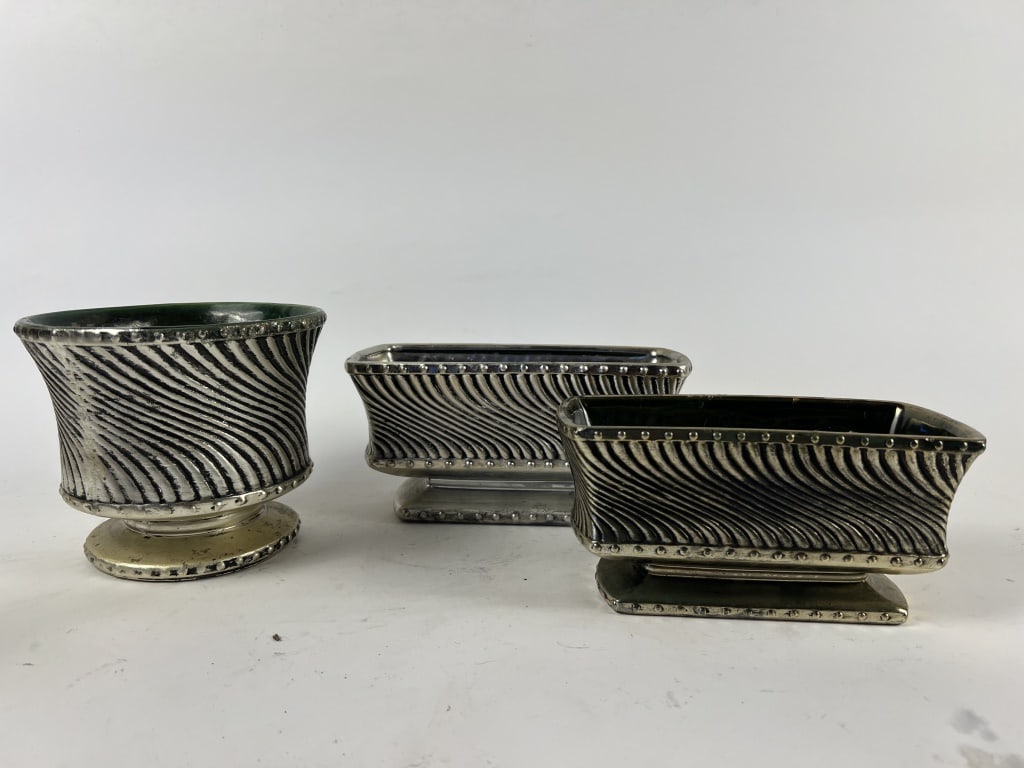 McCoy Floraline silver ribbed swirl (3): Three pieces. Dimensions: Tallest: H 5.25" x Dia: 6.25" Condition: Some losses to silvering, edge roughness.