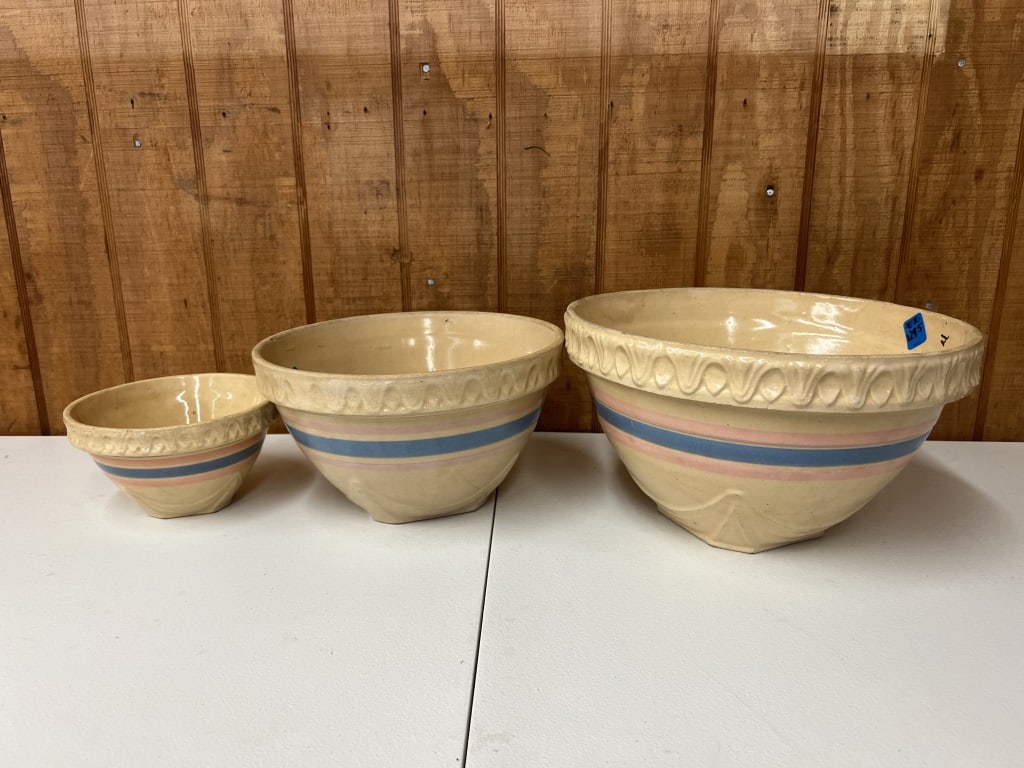 (3) McCoy stoneware mixing bowls: Pink and blue striped. Three sizes, marked USA. Dimensions in photos. Condition: Showing signs of age and use mostly to smallest.