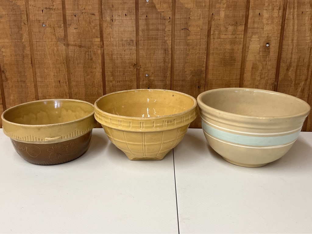 (3) Stoneware mixing bowls: A McCoy? yelloware bowl 9.5" in diameter, etc. Condition: Some signs of age, crazing.