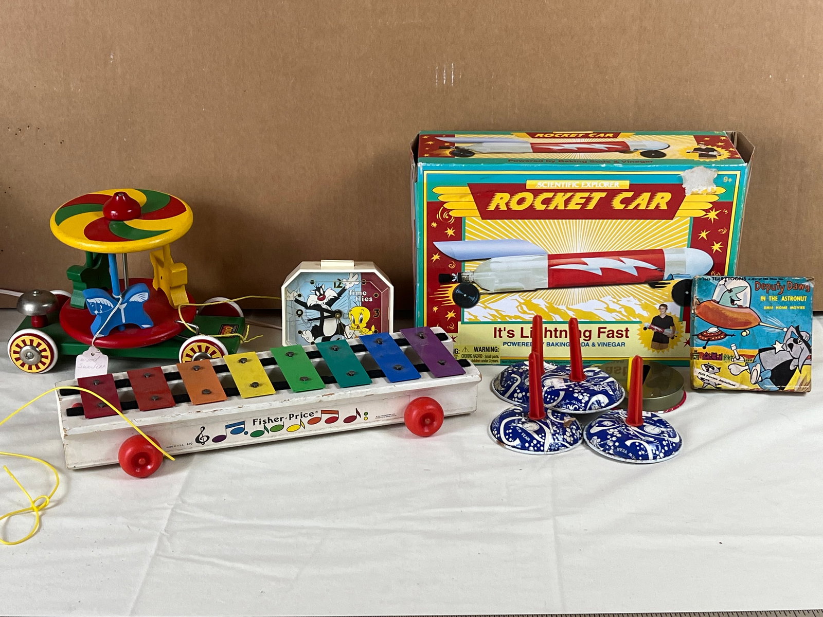 Grouping of vintage toys: Fisher Price, Brio, Scientific Explorer, Deputy Dog. Showing normal signs of age and use.