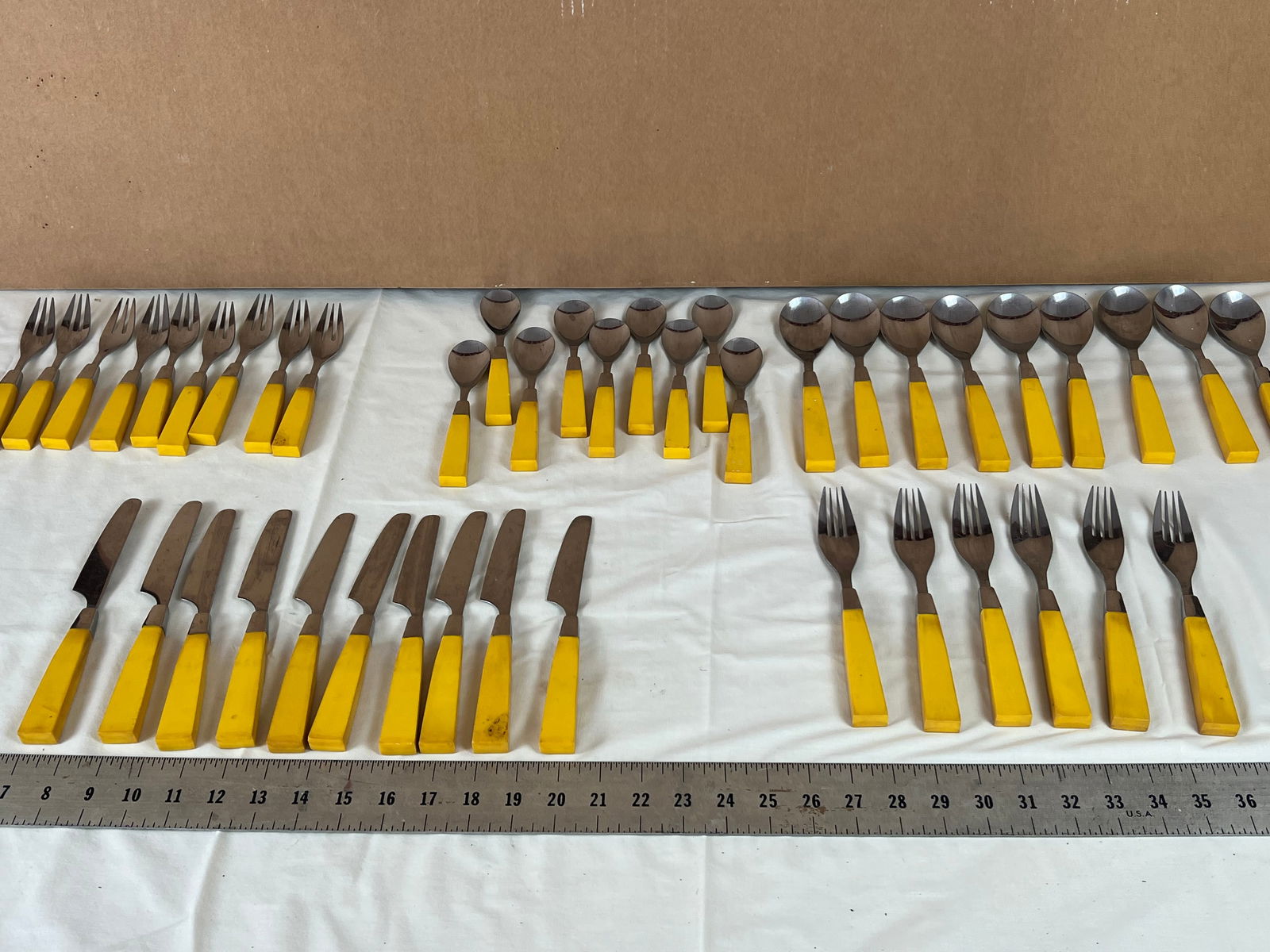 Grouping of Bakelite yellow handle flatware (1 of 8)