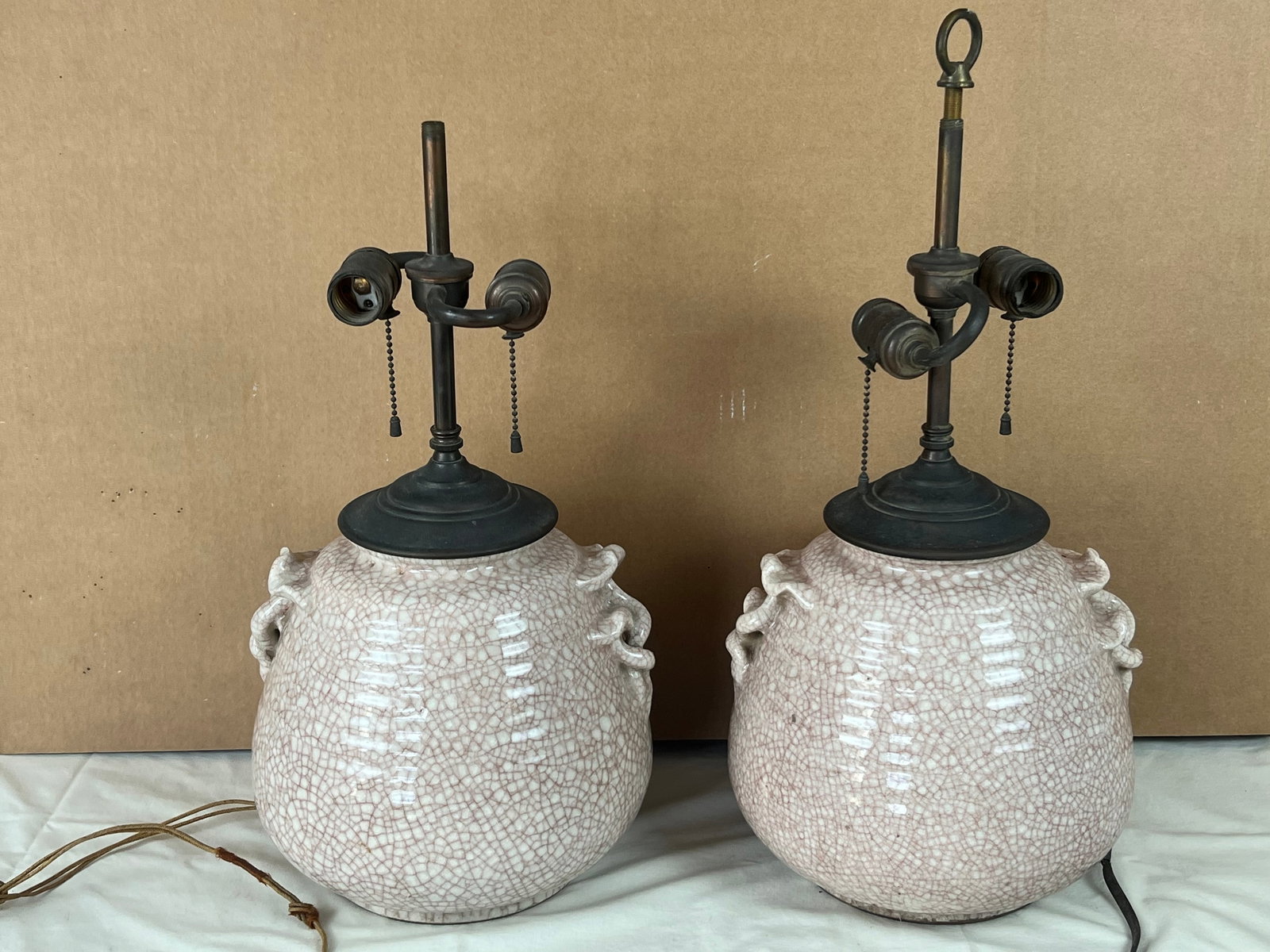 Pair of Japan Crackle glaze lamps antique: One with original cloth wire, marked Made in Japan with paper sticker on bottoms. Dimensions: H 21" (to finial) x W 10" Presenting nicely, one stain, minor flea bites, crazing.