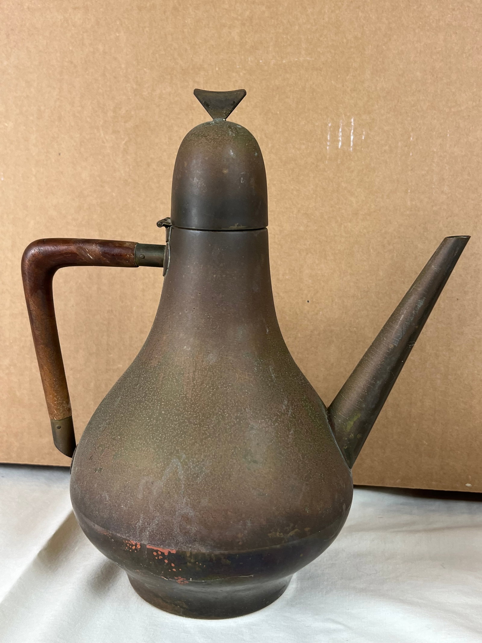 Mid-Centiry Brass Made in Italy Teapot: A modern teapot, brass with wood handle. Definately designer, marked Made in Italy on bottom. Dimensions: H 11" x W 9" Tarnish, no mahor dents, some surface scratching.