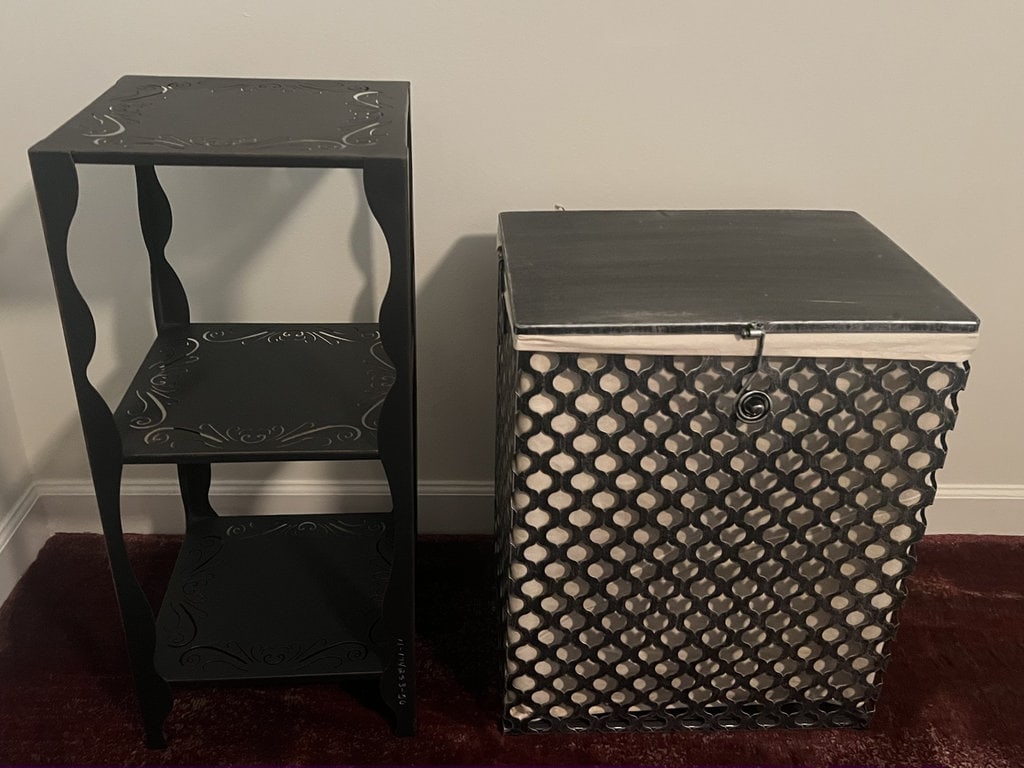 (2) Decorative Objects: Metal 3 tier table and a metal landry basket. Dimensions: Table: H 29.5" x 13" square Only minor signs of use. Low Estimate: 10.00 High Estimate: 100.00