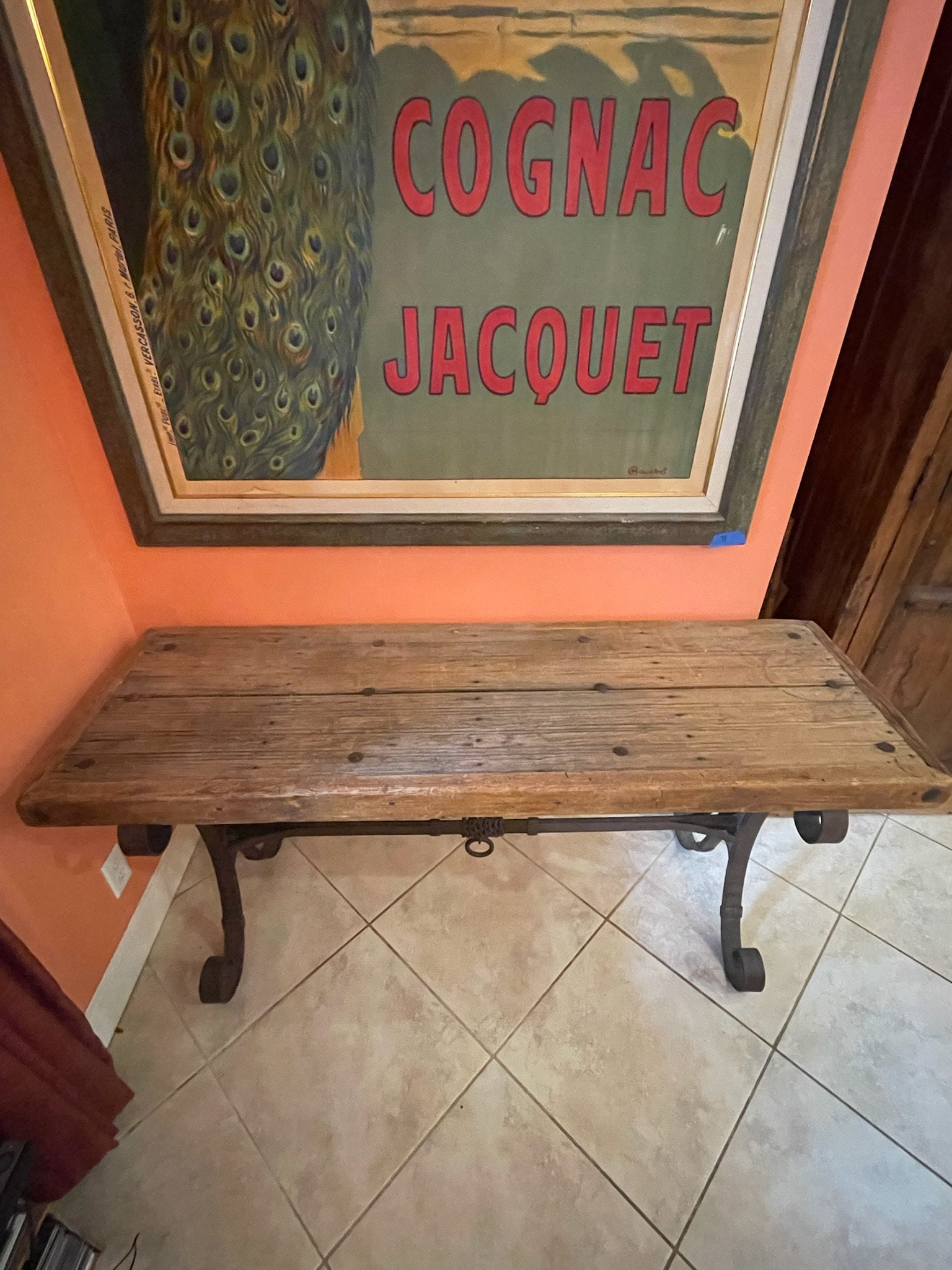 Spanish Style Wrought Iron Console Table: Rustic wood top with iron base. Dimensions: H 30" x W 65" x D 21" Repair to one corner, that area is a bit dry. Low Estimate: 300.00 High Estimate: 500.00