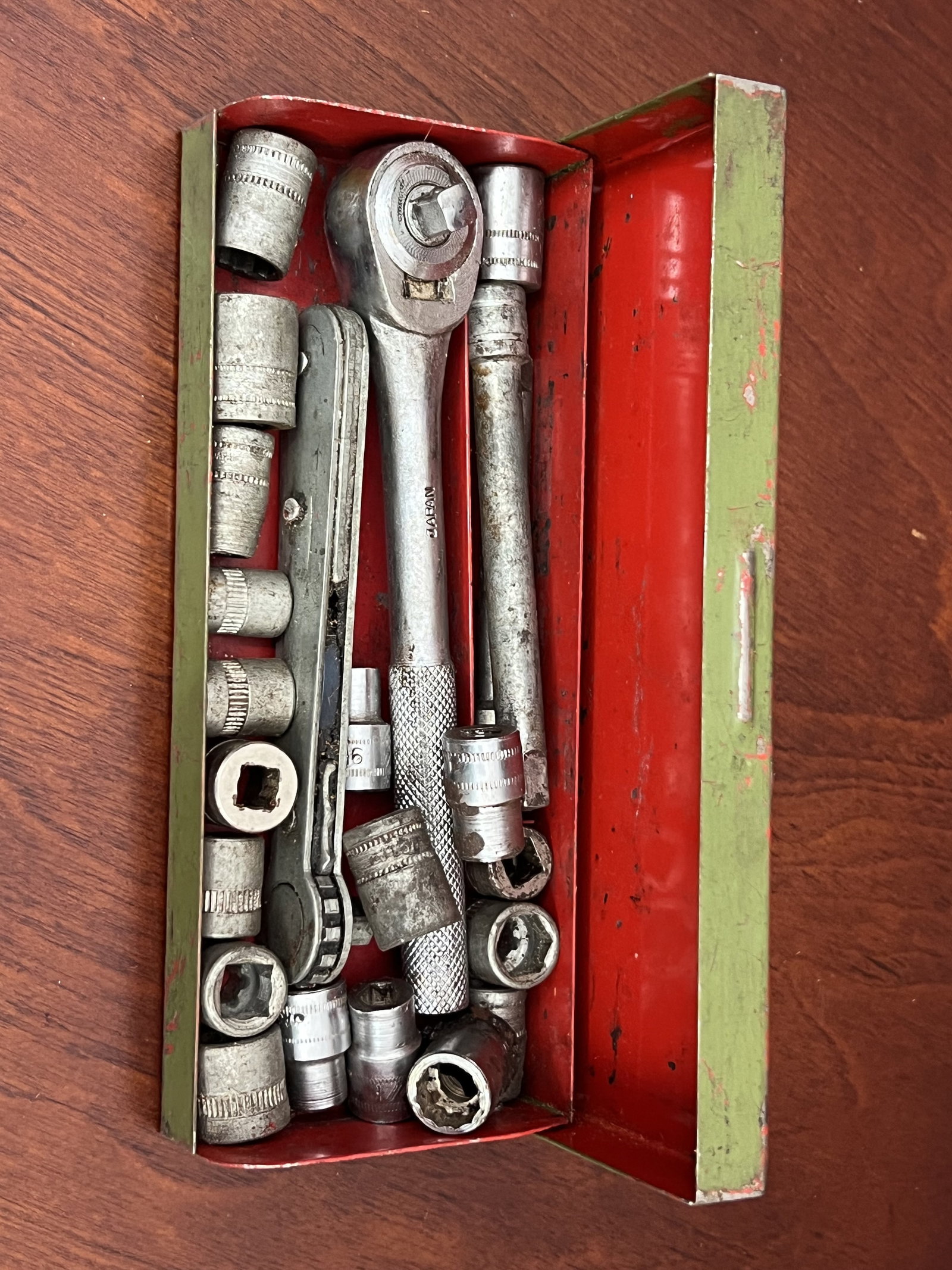Mini Socket Set Japan: Miniature socket set in red and green box. Dimensions: 6.5"x 2.75" Condition: As shown. Low Estimate: 10.00 High Estimate: 1000.00