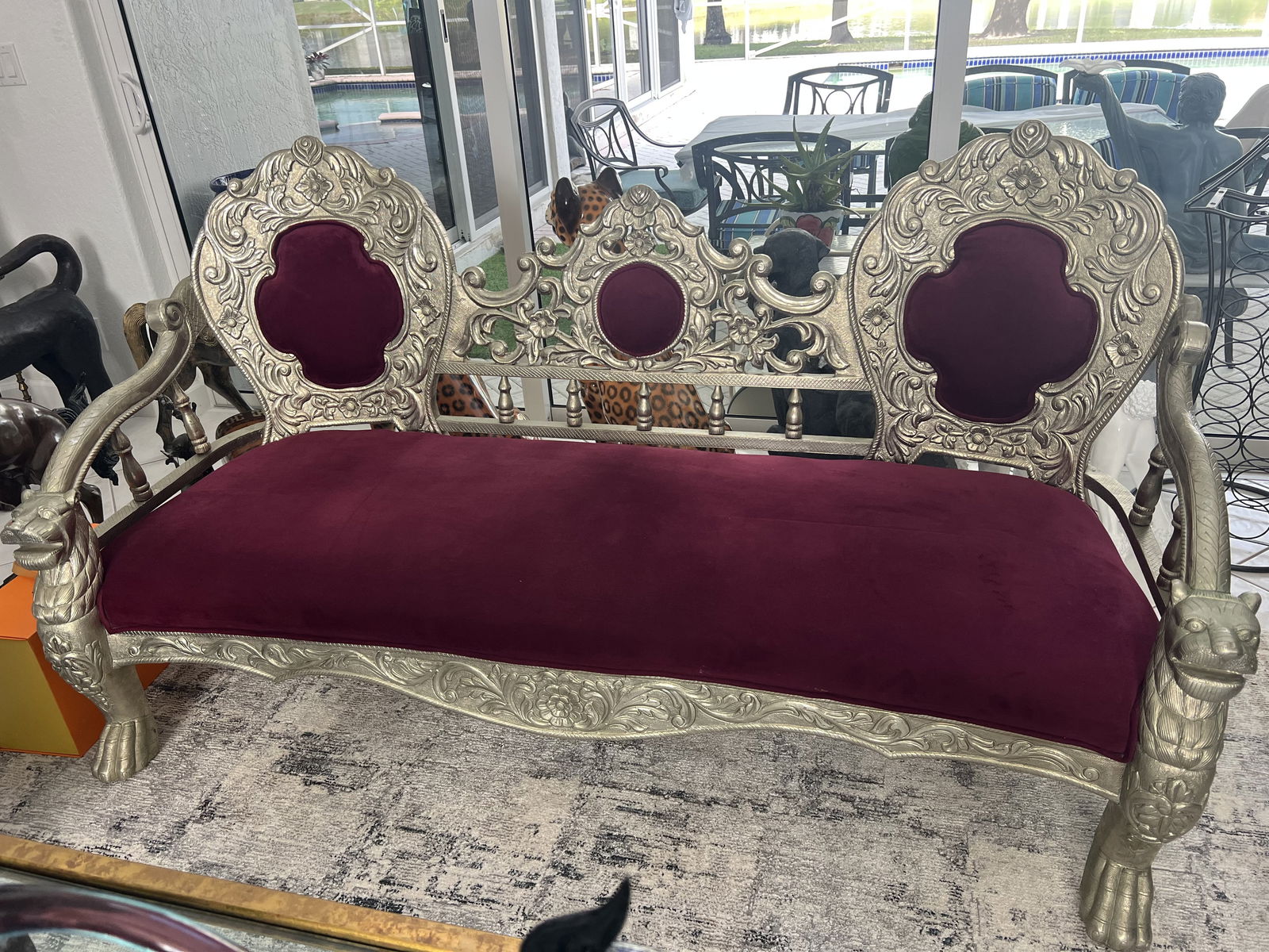 Victorian Silver Lion Head Sofa: A victorian style settee sofa, three seat, lovely velvet, carved wood with lion head accents and silver overlay. A pair of coordinating chairs is the next lot in this auction. Condition: Only minor si