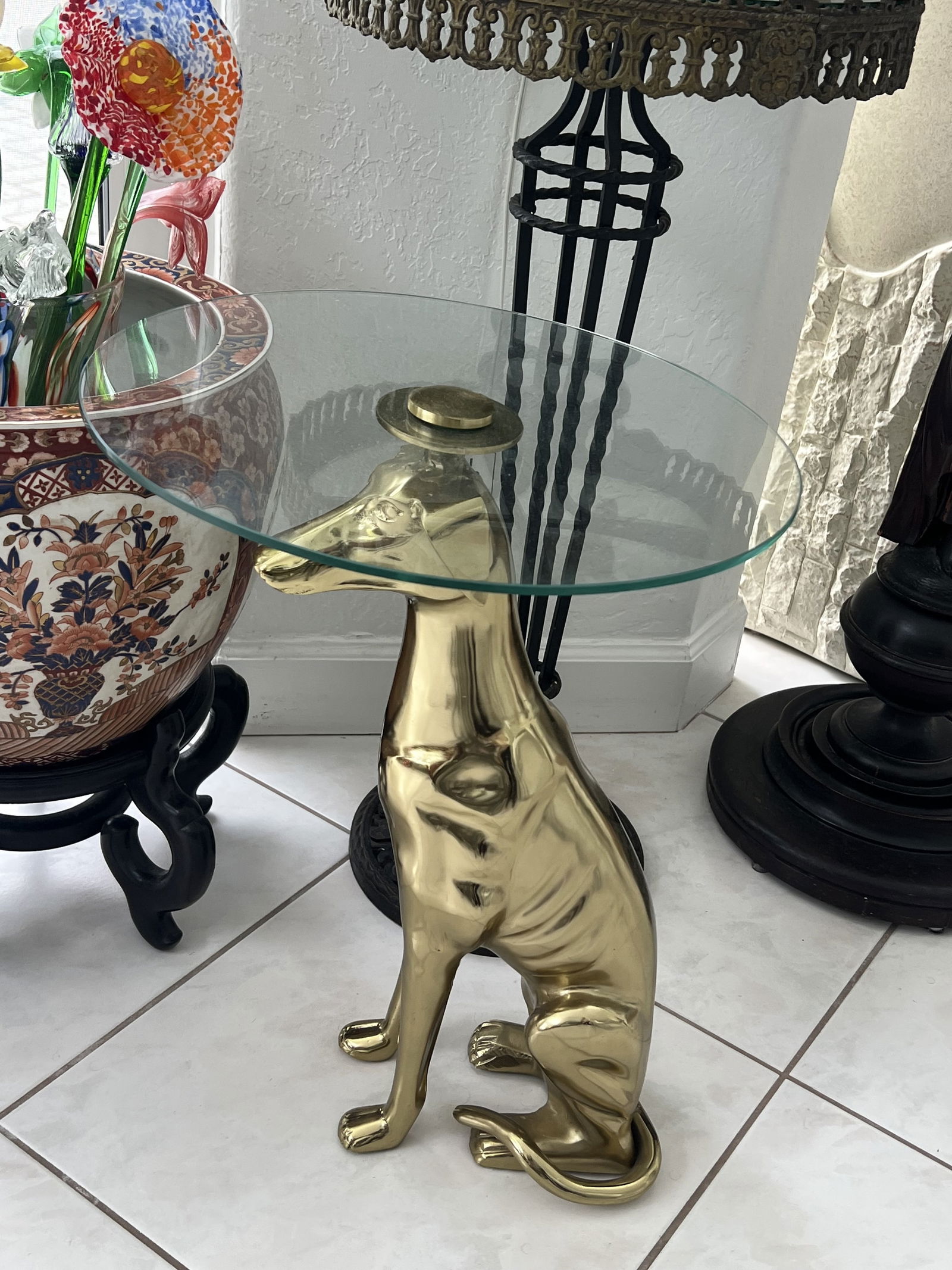 Brass Greyhound Side Table: Art Deco style, glass top, whippet or greyhound dog, brass over metal. Dimensions: H 22" x Dia: 16" Condition: Only lightly used. Low Estimate: 250.00High Estimate: 450.00