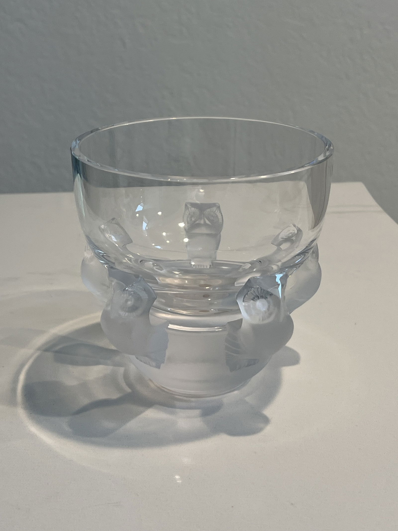 Lalique Crystal Owl Bowl: Signed Lalique France crystal bowl with owls at base. Dimensions: H 5.25" x Dia: 5.25" Condition: One small flea bite, as shown. High Estimate: 350Low Estimate: 250