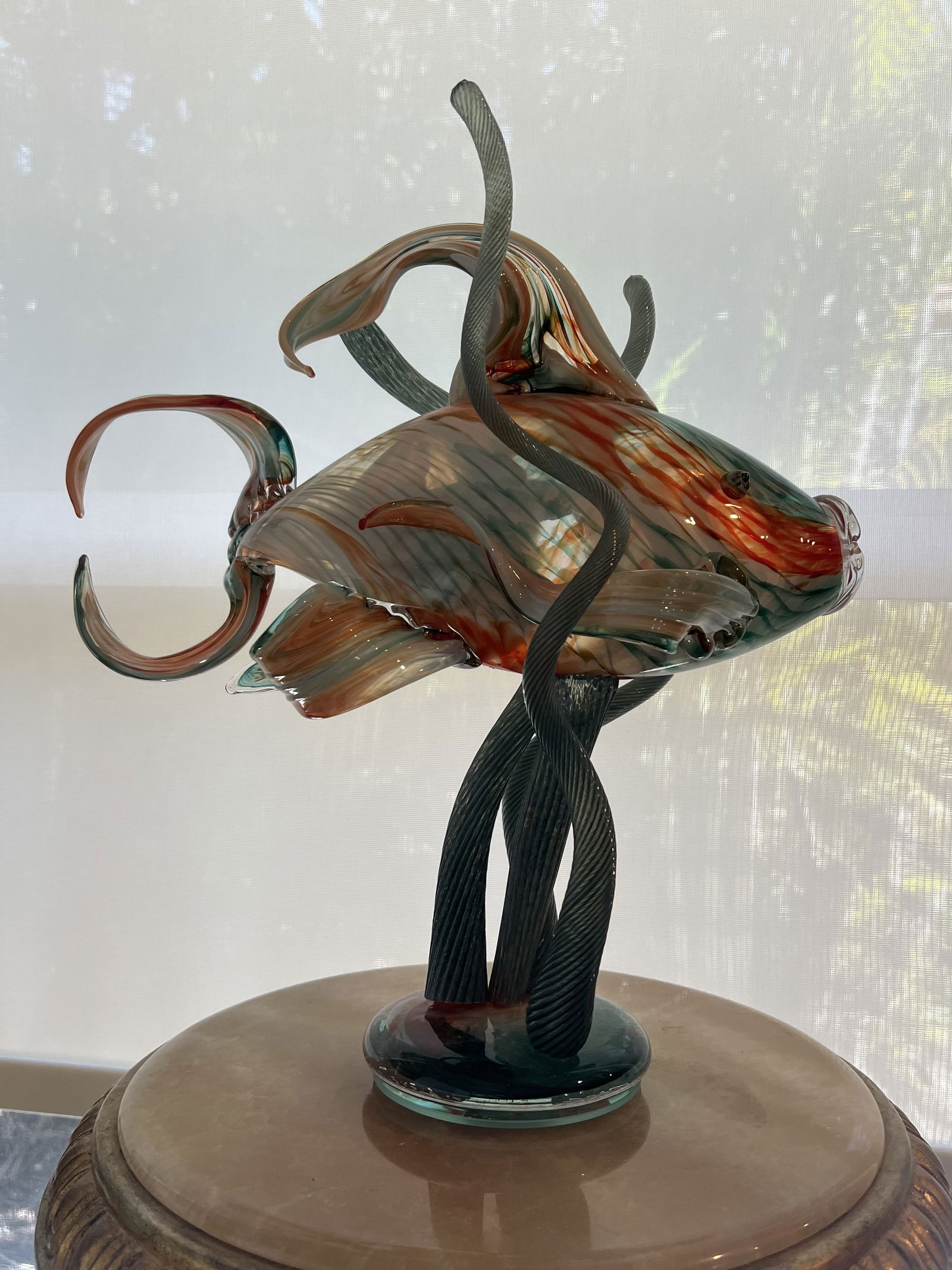 Italian Murano Fish Sculpture: Murano style vintage glass fish in seaweed, colors are orange/rust, lime blue green. Dimensions: H 13" x L 13" x D 7" Condition: Presenting well, no issues to note. Low Estimate: 300.00High Estimate: