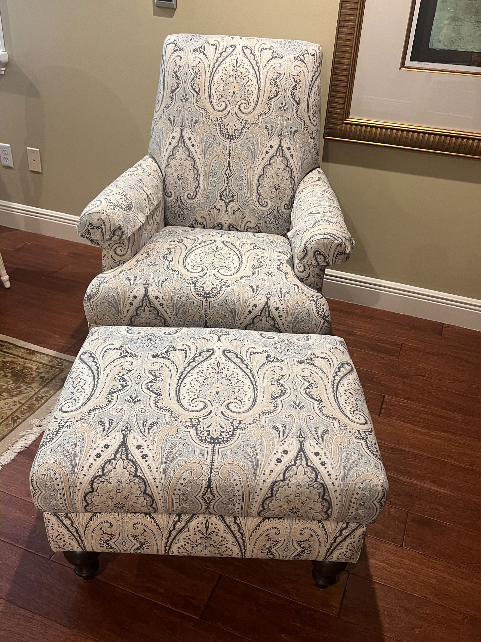 Bassett Furniture Co Arm Chair and Ottoman: A lovely, soft and cozy armchair in soft blue, white and beiges. Dimensions: H 41" x W 33" x D 32" x Seat Height: 19" Ottoman: L 28" x W 23" Condition: No issues to note, clean. Low Estimate: