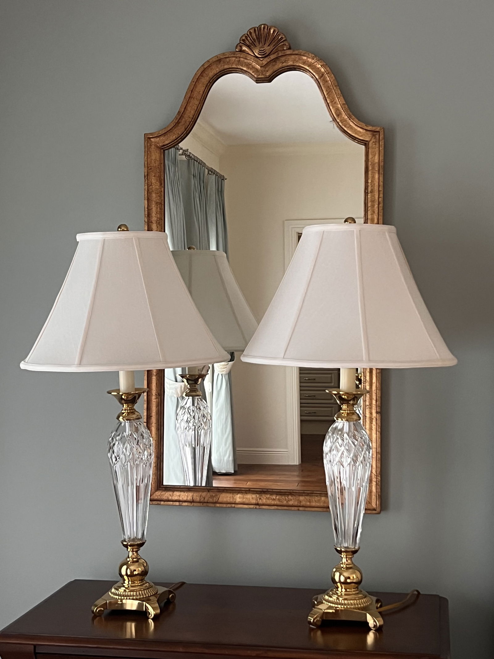 Pair of Waterford Crystal Lamps: A matched pair of Waterford crystal and brass table or bedside lamps. Dimensions: H 33" x W 6" (base) x Dia: 18" (shade) Condition: only light signs of use. Low Estimate: 10.00High Estimate: 10000.00