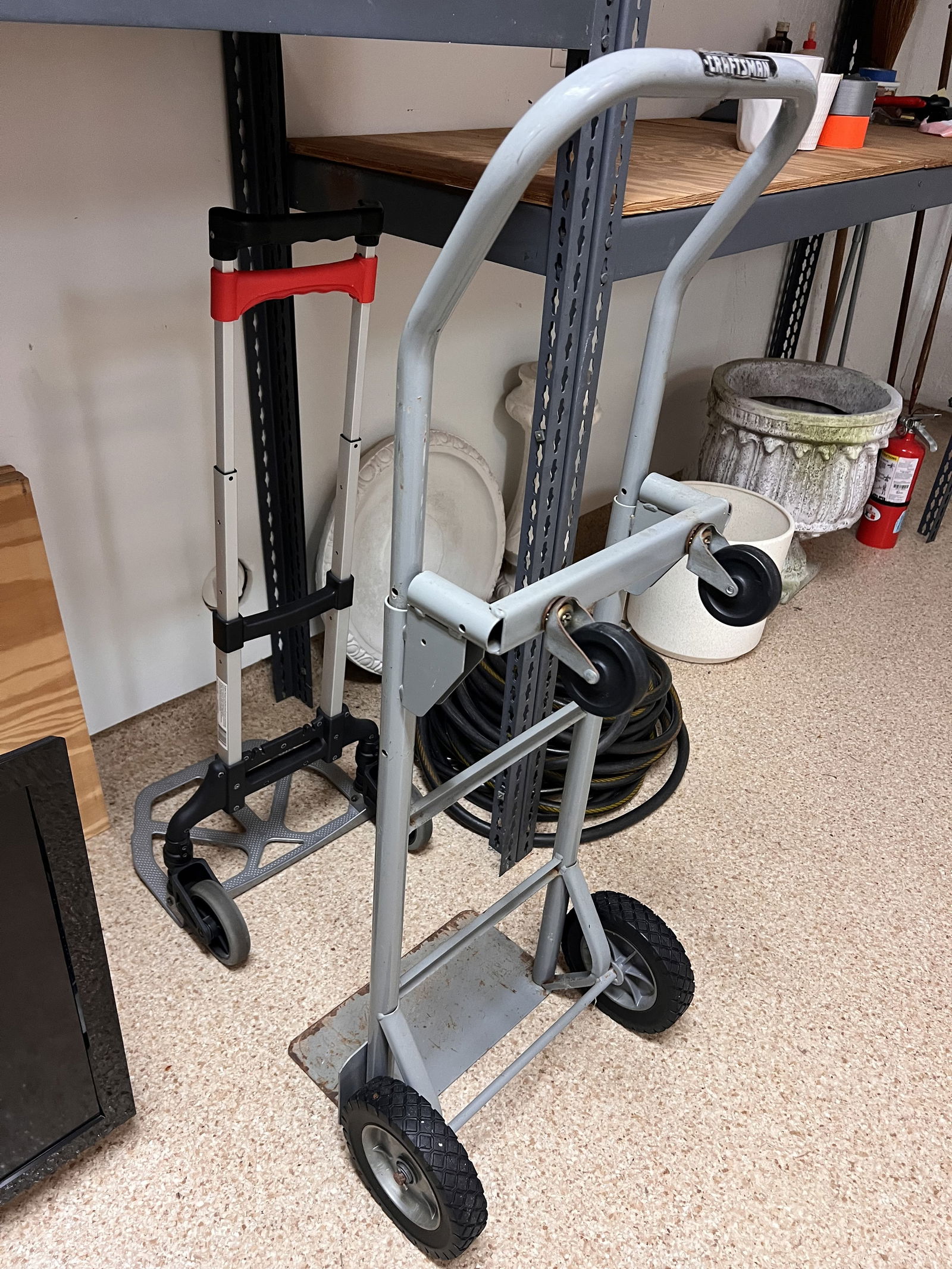 Moving Hand Trucks: (2) moving hand trucks or dollys, one folding. Condition: Signs of use. Low Estimate: 10.00 High Estimate: 10000.00