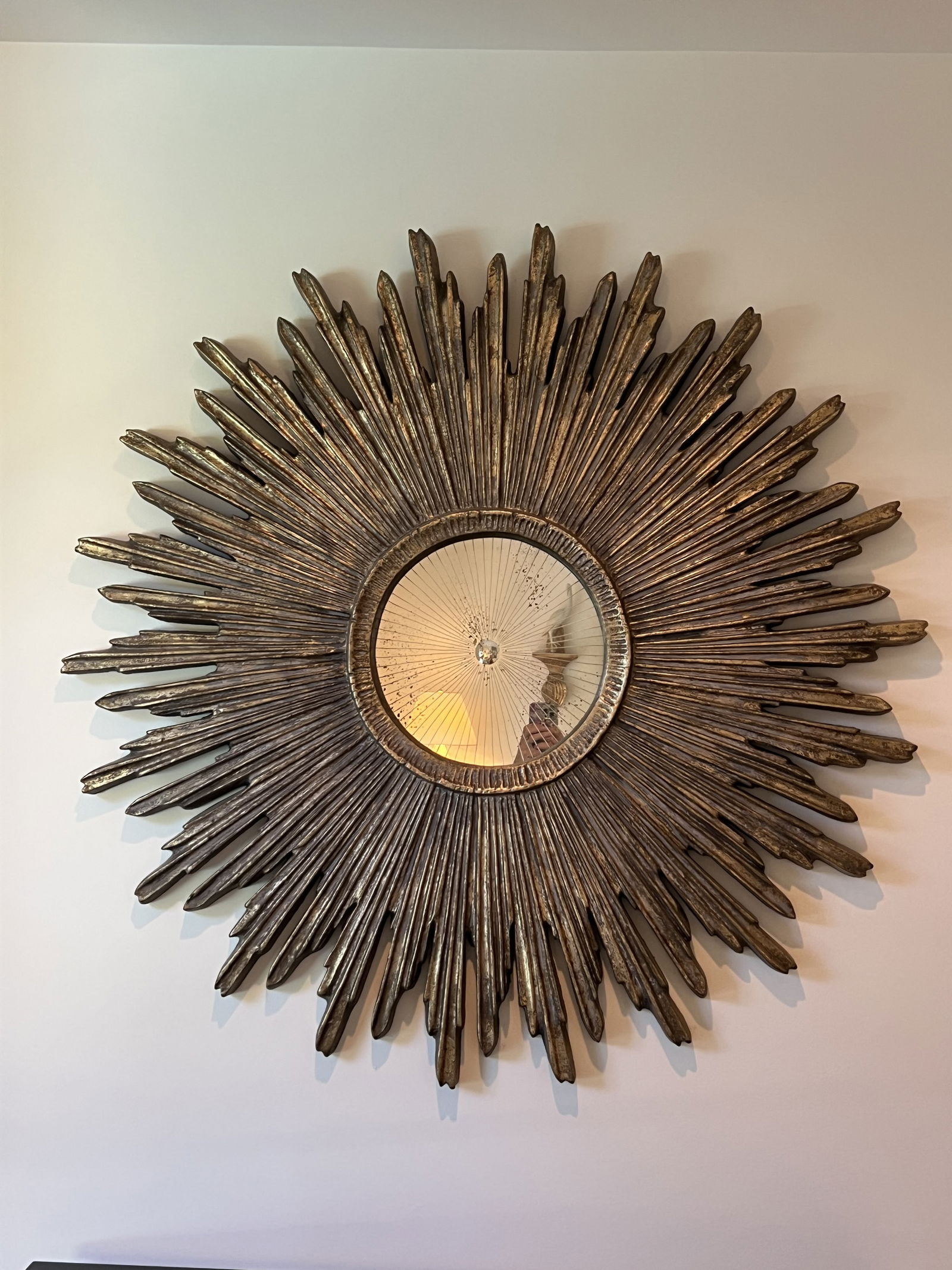 Large Sunburst Mirror: Not antique, a designer quality with Italian style gold finish, antiqued and etched mirror. This piece is made of foam and is pretty easy to hang. Dimensions: Dia: 45" x 1.5" thick x 12" mirror Low