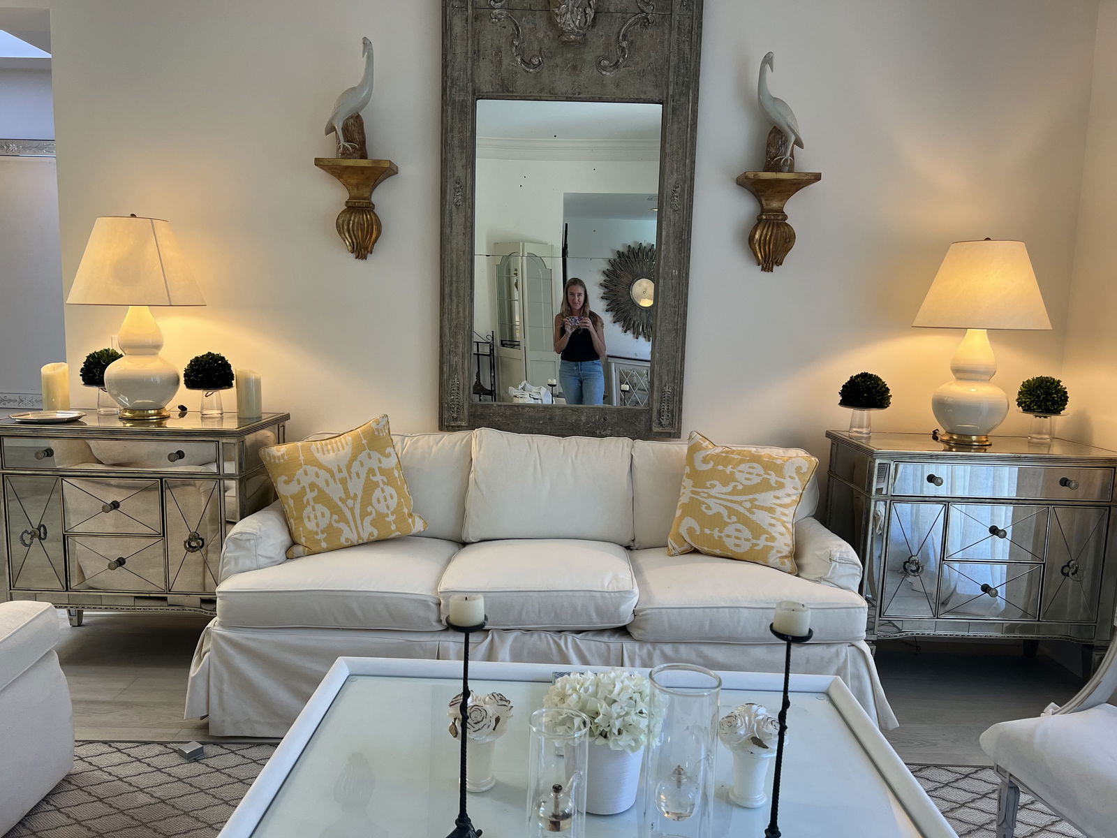 Pair of Mirrored Hollywood Regency Style End Table: A pair of end table or accent chests with beveled and smoked mirrors, antique silver leaf trim with nice patina look. 5 drawers. Dimensions: H 34.5" x W 36" x D 19" Condition: Only very minor