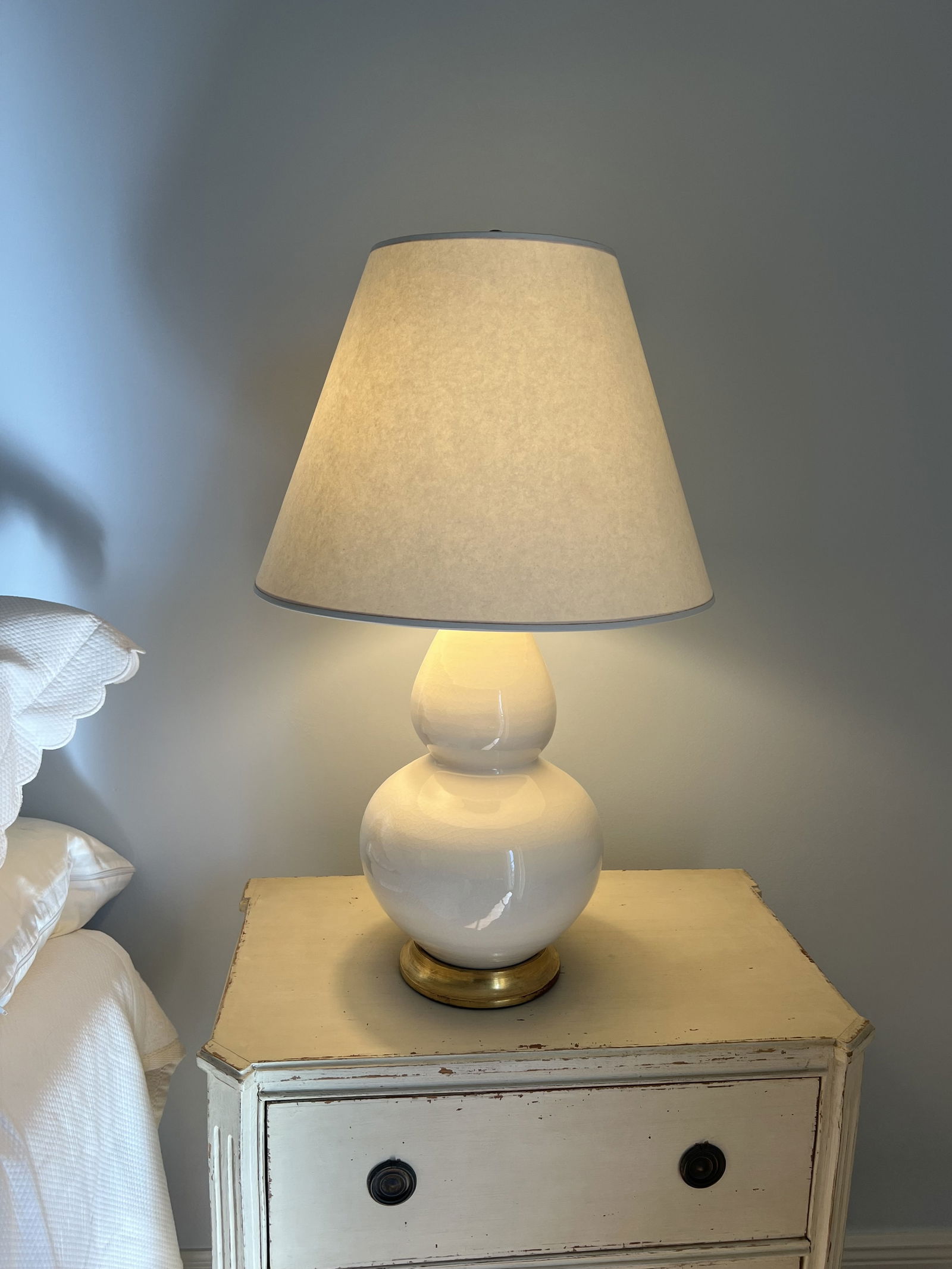 Pair of Christopher Spitzmiller Lamps: Off-white bulbous double gourd form ceramic, crackle glaze lamps, gold leafed bases. Dimensions: H 30" x Dia: 10" (lamp diameter, not including shade) Condition: No issues to note, presenting well.