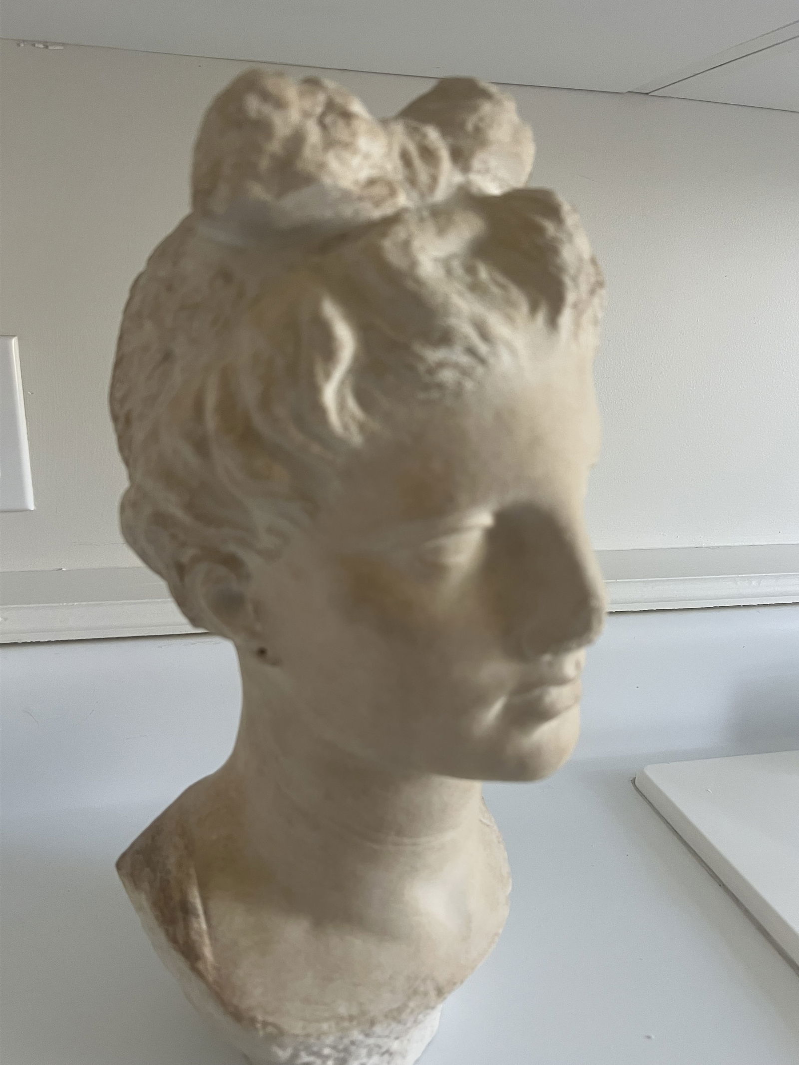 MMA Greek Marble Head Funerary Statue: A reprodcution by the Metropolitan Museum of art of a young woman head. The original was likely park of a shrine for a grave. Plaster. Dimensions: H 15" x W 7" x D 6" Condition: No issues to note,