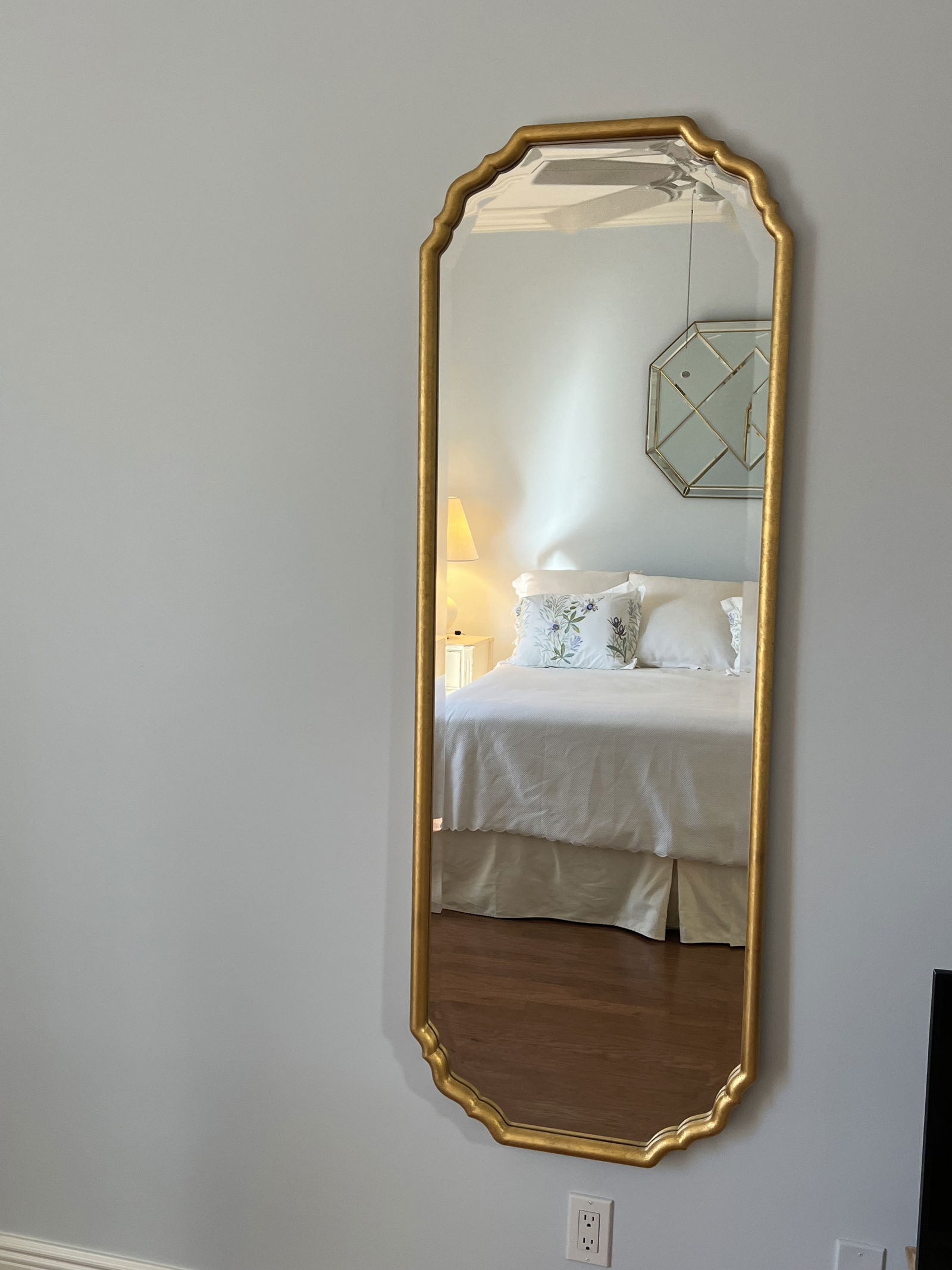 Contemporary Gold Leafed Mirror: Vintage Italian style but a reproduction. Qaulity construction with deep bevel, luxurious curves and gold finish. Likely retailed at One Kings Lane. Dimensions: H 61.5" x W 21.1" Condition: