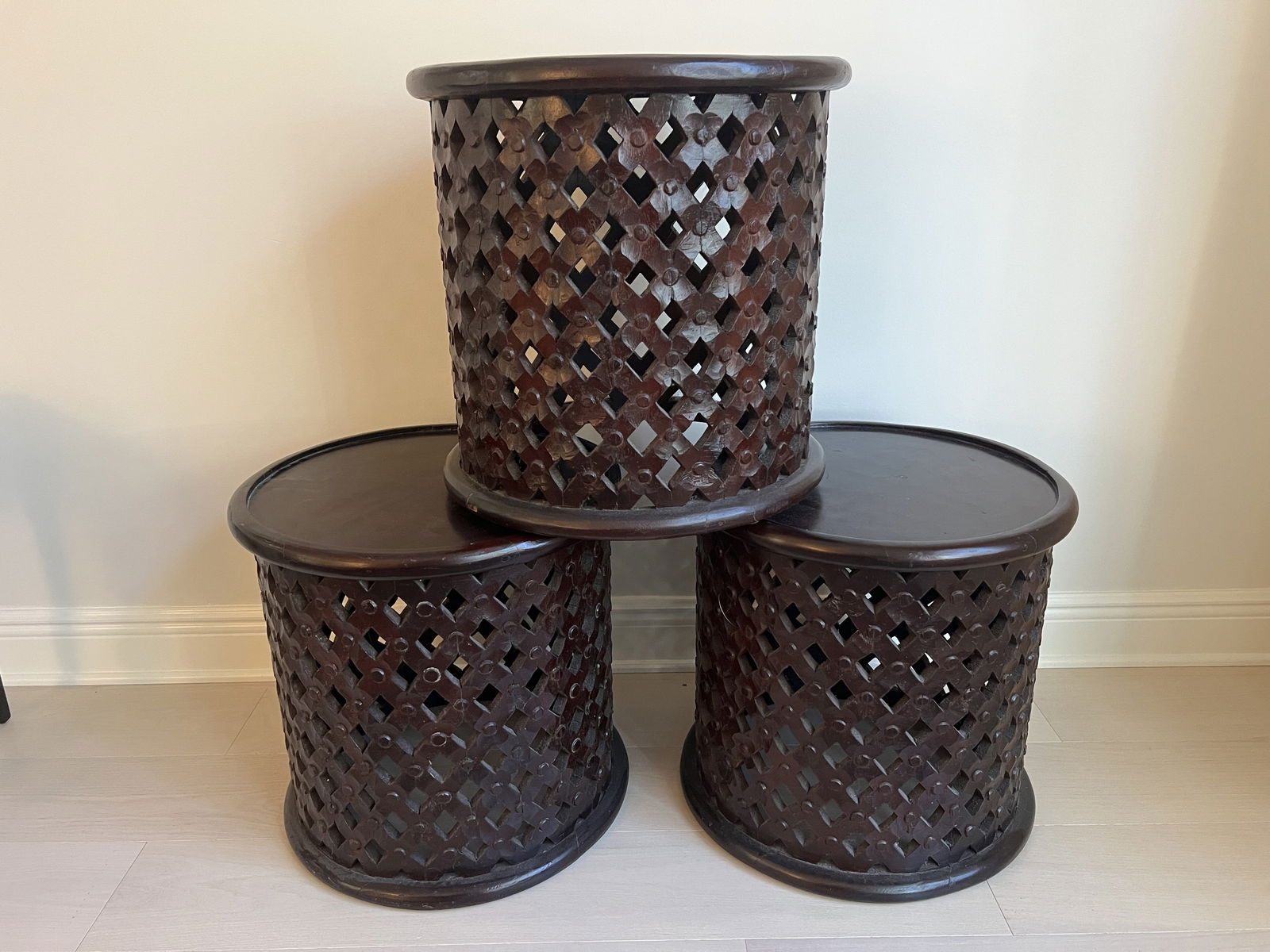 (3) Carved Drum Or Bamileke King Stools: Traditional African chief style, carved wooden stools. A nice set of three, would make great end tables too. Dimensions: H 18" x Dia: 18" Condition: Minor signs of age to the wood, presenting well.