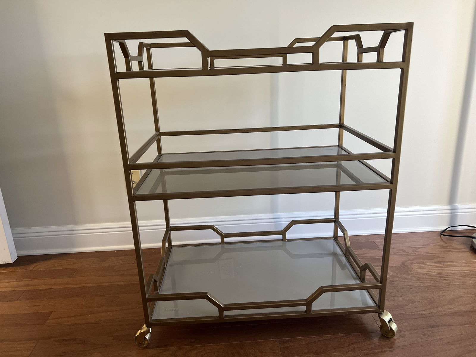 Hollywood Regency Brass Bar Cart: Jules bar cart by Ballard Design, Hollywood Regency style brass or gold tone. Three selves, the sheels are a little slow to roll. Dimensions: H 37" x W 30" x D 20" Condition: Lightly used. Low Estima