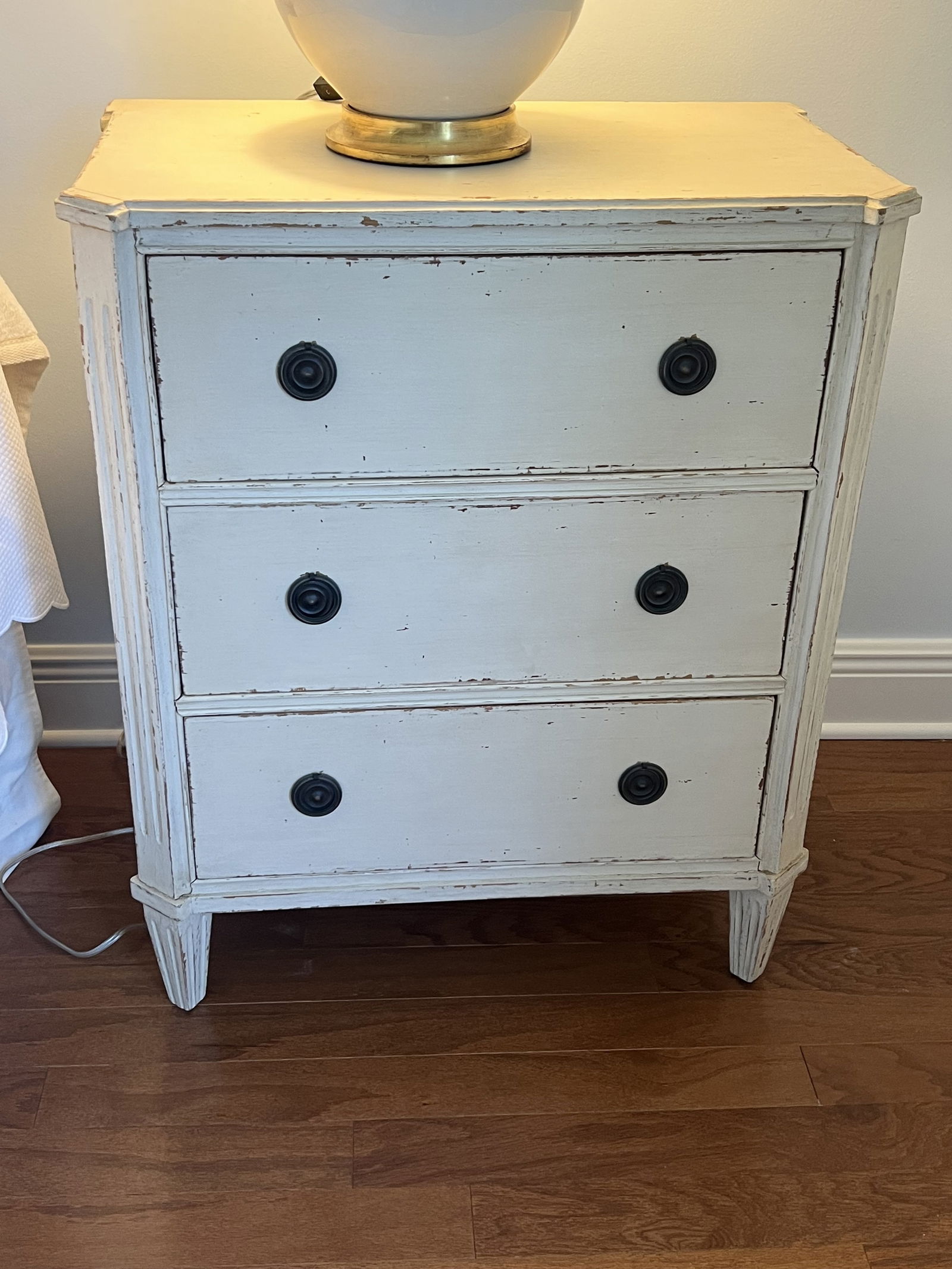 Pair of Swedish Style Three Drawer Nightstands: Gustavian or Swedish Painted Night stands. Off white country, antique painted bedside chests. Dimensions: H 31.5" x W 26" Condition: Very good, presenting well. Low Estimate: 10.00High Estimate: