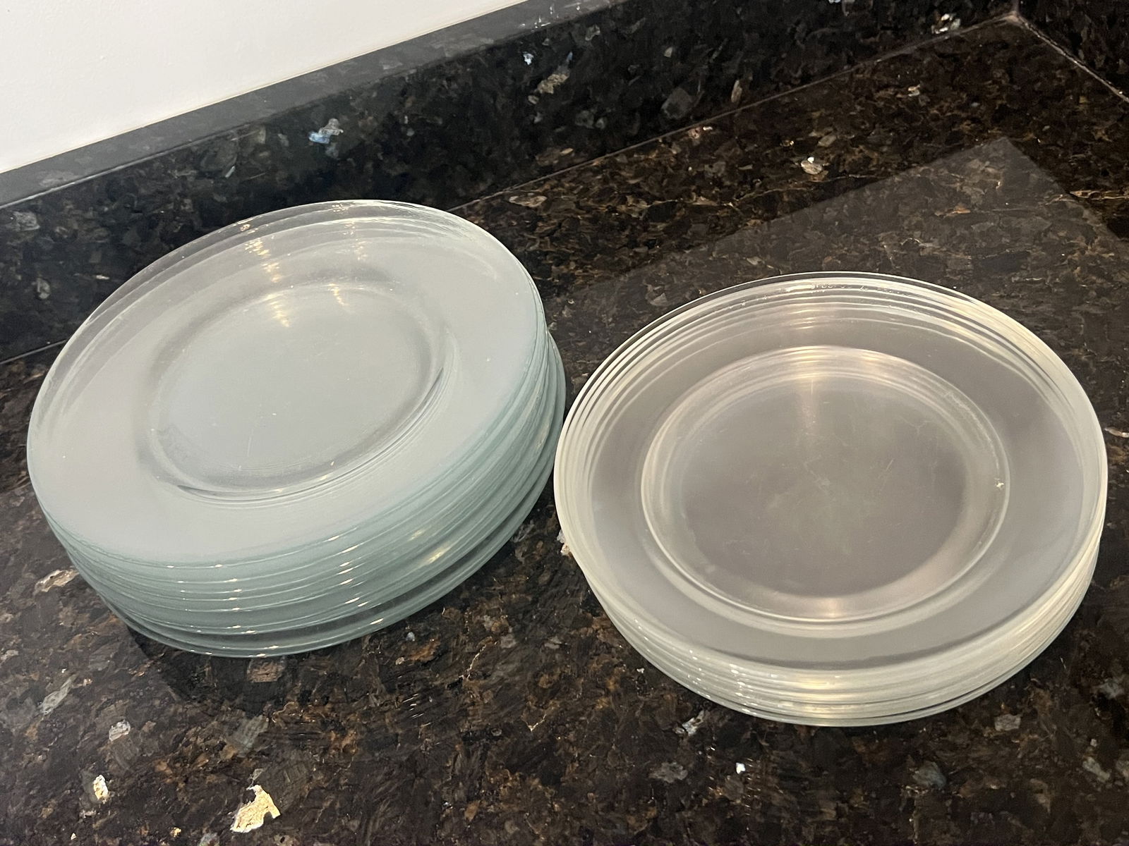 Arcoroc Clear Glass Plates: Smaller plates are marked Arcoroc France, the larger just have a number. Dimensions: 7.75" and 6.75" Condition: Colors differing between the two stacks, some surface marks. Low Estimate: 10.00High