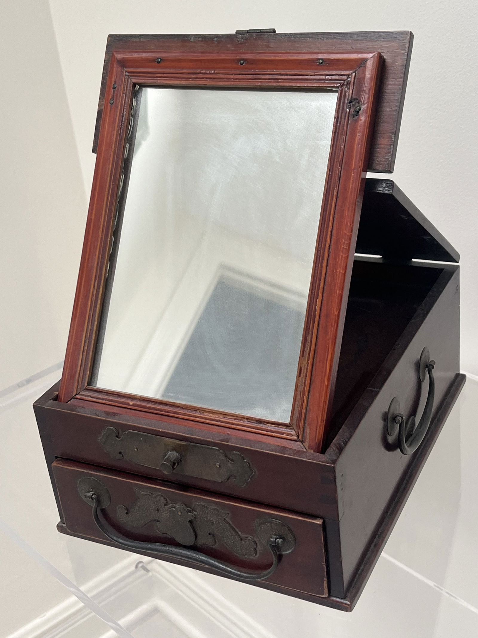 Vintage Chinese Traveling Vanity Box: A folding mirror and single drawer and hidne keyhole. Dimensions: H4.75" x L 11" x D 9" Condition: Presenting well, nice patina. Low Estimate: 10.00High Estimate: 10000.00