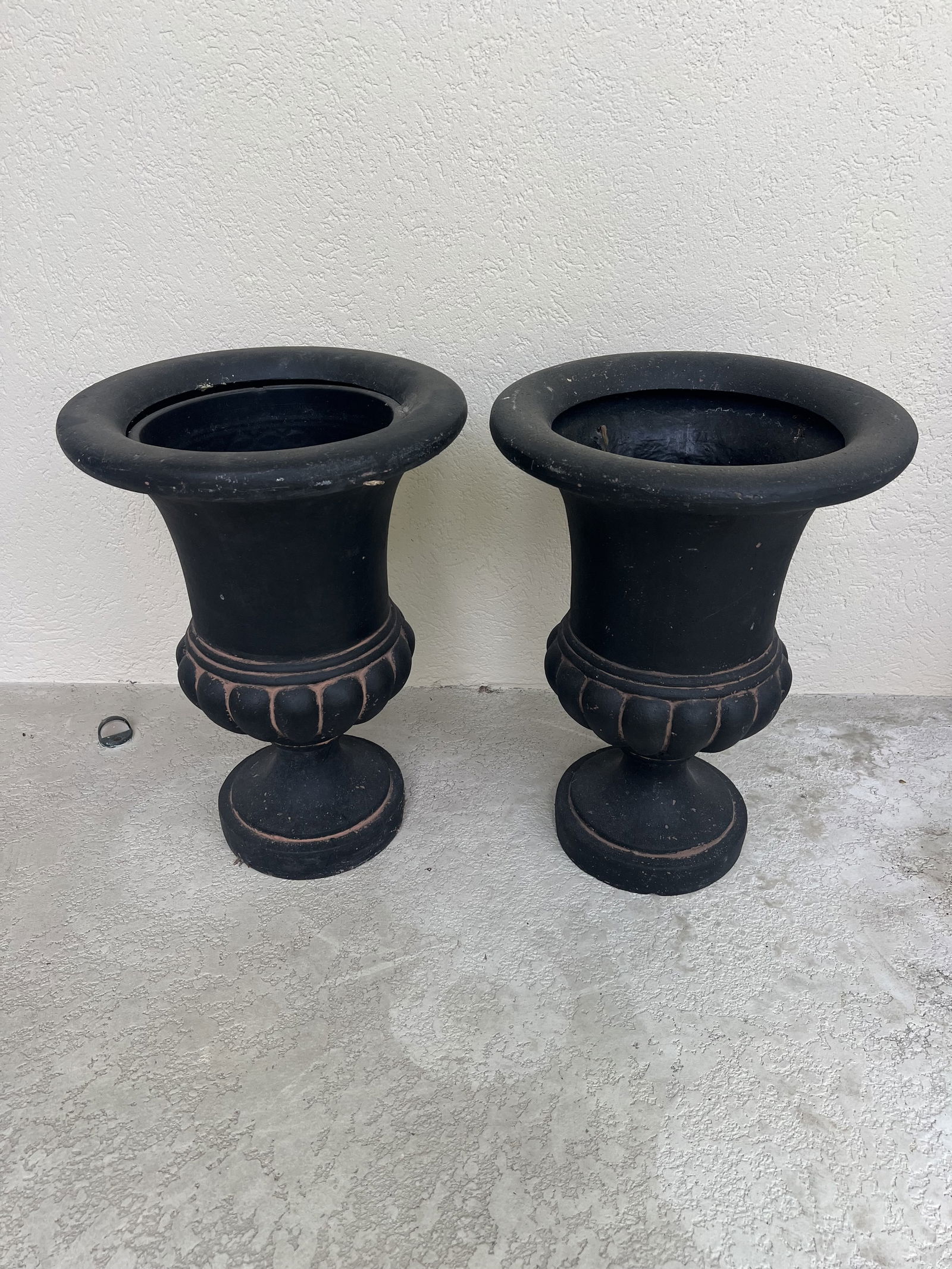 (2) Resin Urn Planters: Classic urns for outdoor plants, resin composite material. Dimensions: H 21" x Dia: 15.5" Condition: Signs of use age, only marks no cracks or breaks. Low Estimate: 10.00High Estimate: 10000.00