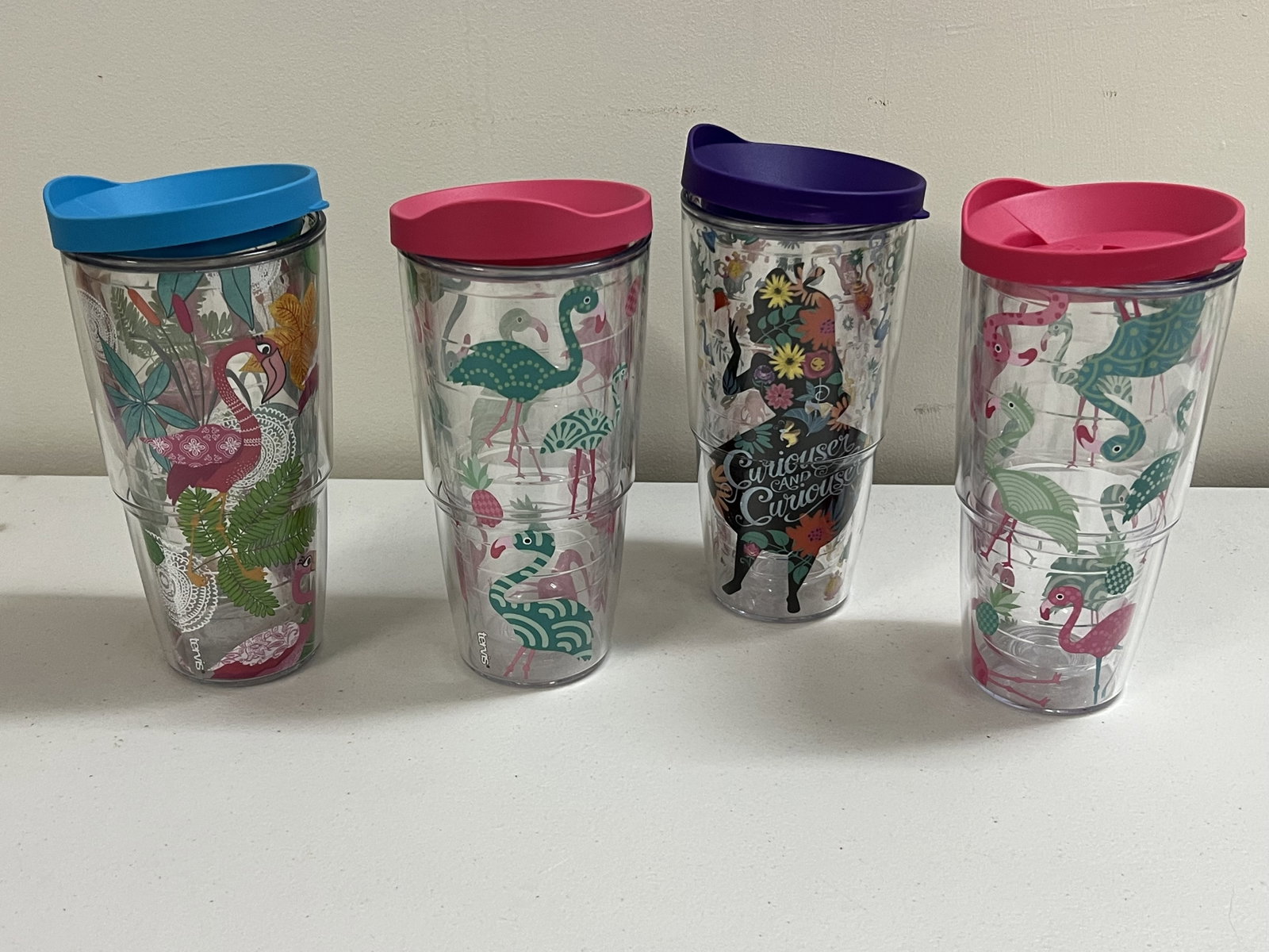 (4) Tervis Travel Cups: (4) 24 Oz Tervis cups with lids. Mostly flamingo themed. Condition: Minor use, no signs of use. Low Estimate: 10.00 High Estimate: 10000.00