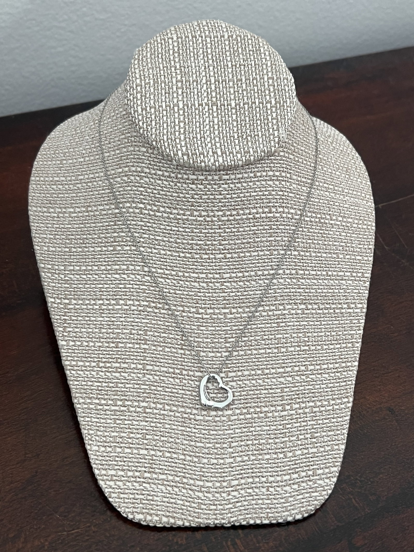 Elsa Peretti Tiffany & Co Platinum and Diamond Open Heart Pendant Necklace: Elsa Peretti for Tiffany & Co platinum and diamond necklace. Dimensions: Necklace: 16" Pendant: Slightly more than 0.50" Weight: 6.2 dwt Condition: used, minor scratches. Low Estimate: 10.00 High