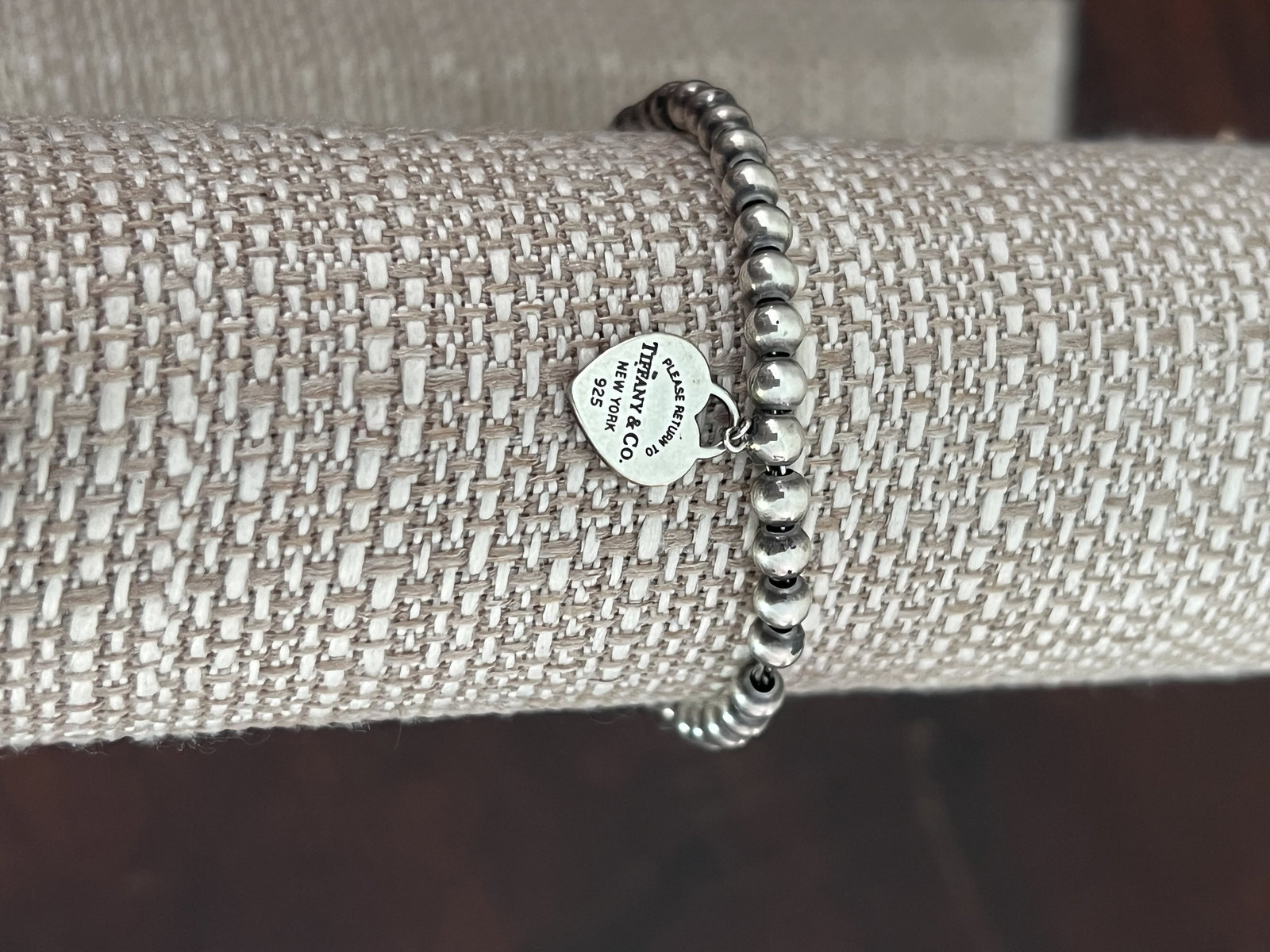 Return To Tiffany & Co Green Enamel Heart Bracelet: Hallmarked Tiffany & Co beaded bracelet with green enamel Return to Tiffany heart. Dimensions: L 7" Heart: 0.50" Weight: 9.5g Condition: Minor signs of use. Low Estimate: 10.00 High Estimate: 10000.00