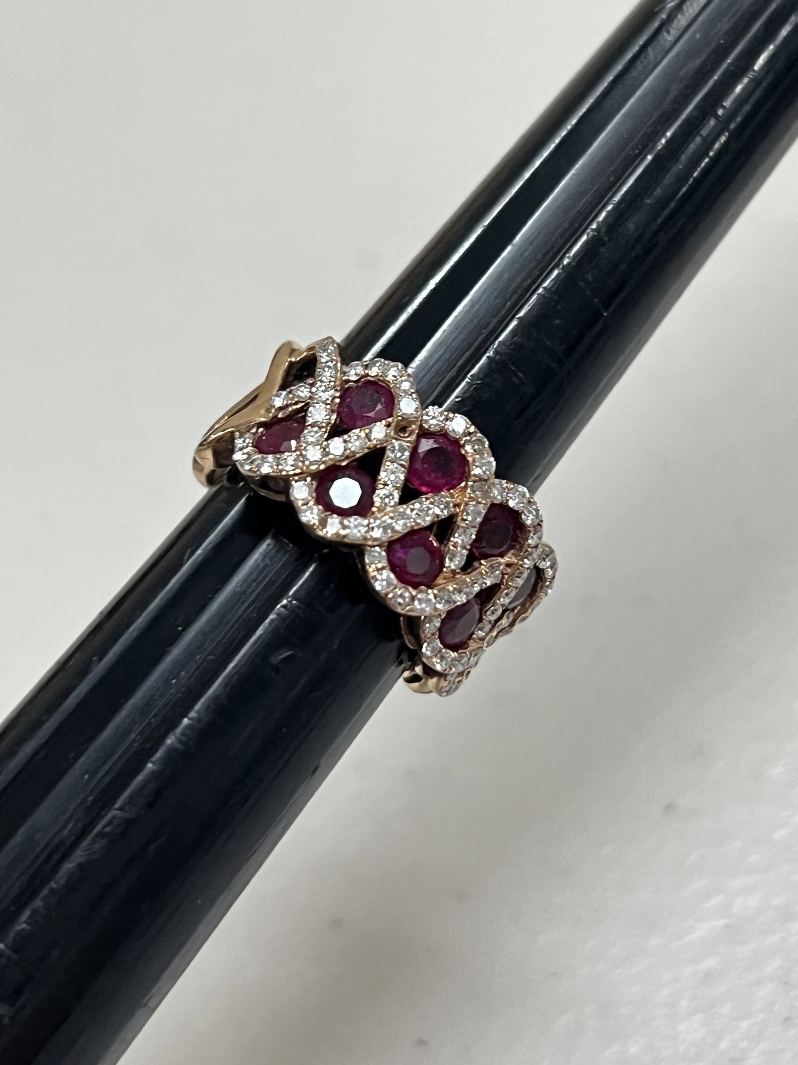 18K Rose Gold, Ruby (Pink sapphire) and Diamond Ring: A cocktail or statement band with rubies and diamonds set in 18k rose gold. Dimensions: W 0.50" Weight: 8.2 dwt Condition: Used, some surface scratches. Low Estimate: 10.00 High Estimate: 10000.00