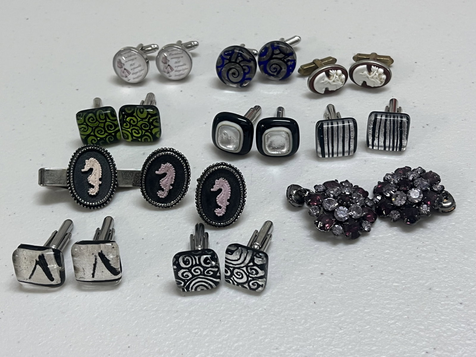Collection of Cufflinks: Art Glass, Sea horses, rhinestones, cameos and more! Dimensions: Rhinestone: Dia: 3" Condition: Good, used. Low Estimate: 10.00 High Estimate: 10000.00