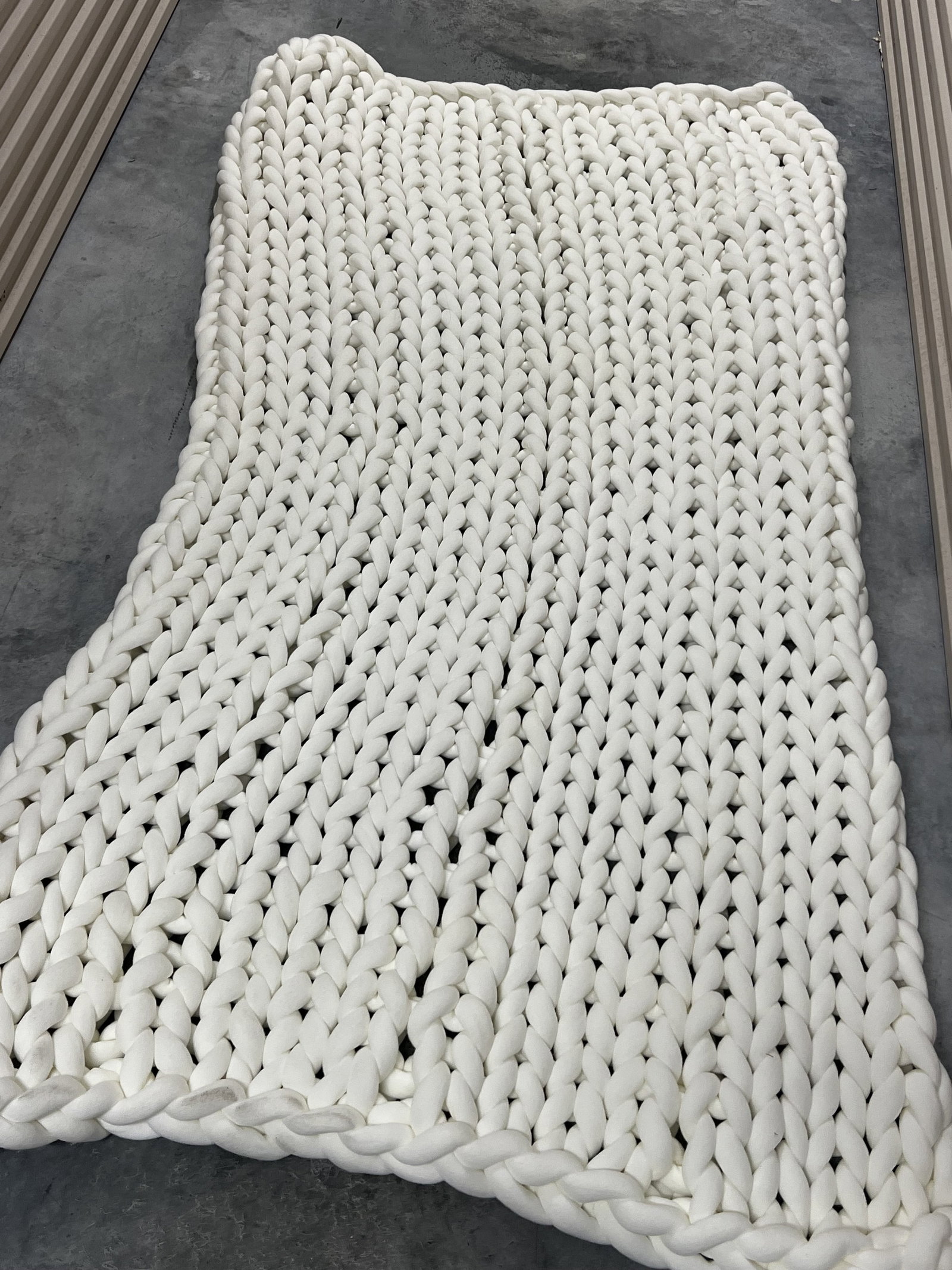 Chunky Knit Whit Throw or Rug: Loops Studio. Dimensions: 77" x 43" Condition: Minor dirt from photography, clean otherwise. Low Estimate: 10.00 High Estimate: 10000.00