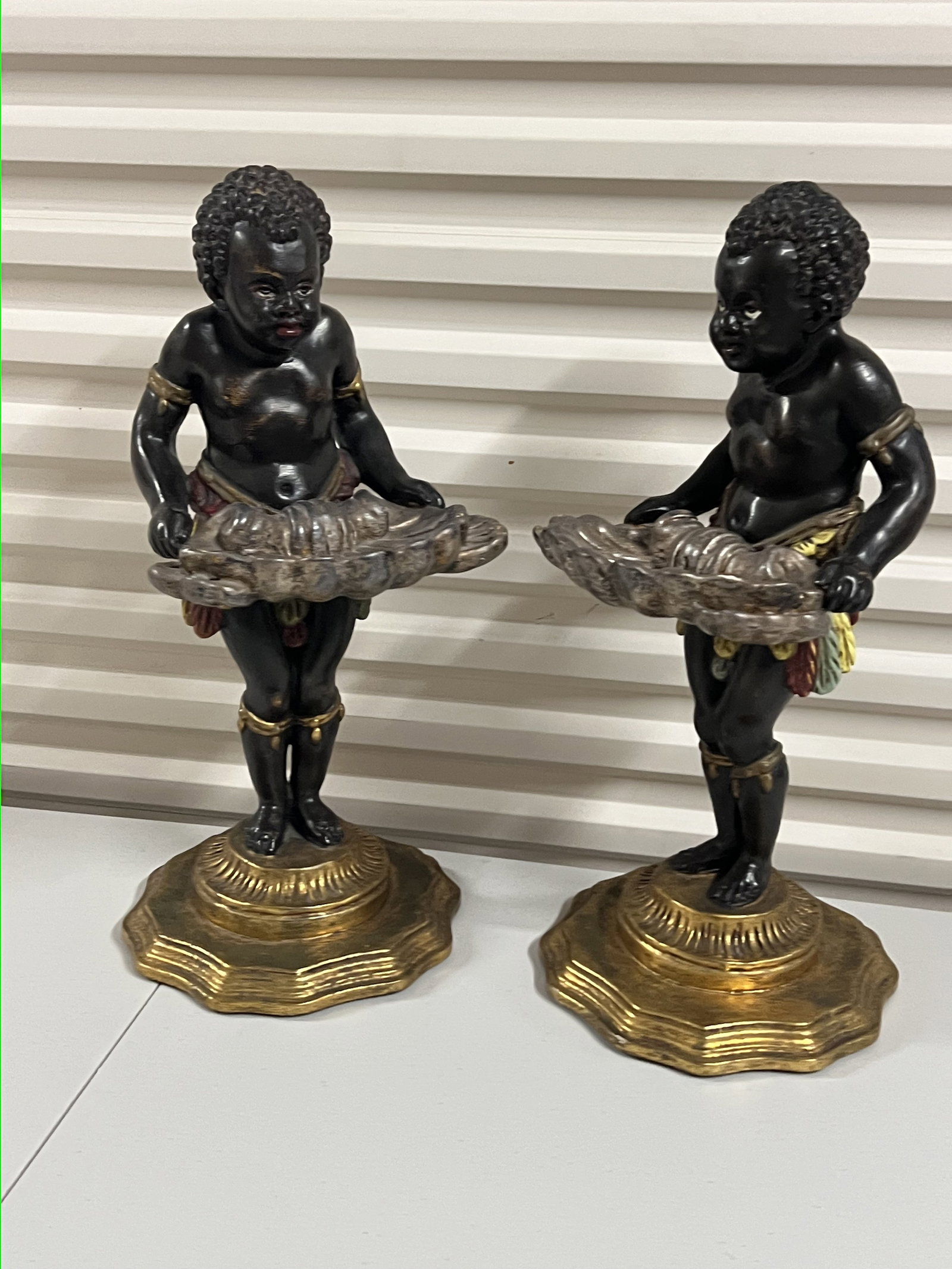 (2) Nubian Vide Poche Blackamoor: Venetian style, wood. Dimensions: H 18" x Dia: 8" (base) Condition: Minor marks. Low Estimate: 10.00 High Estimate: 10000.00