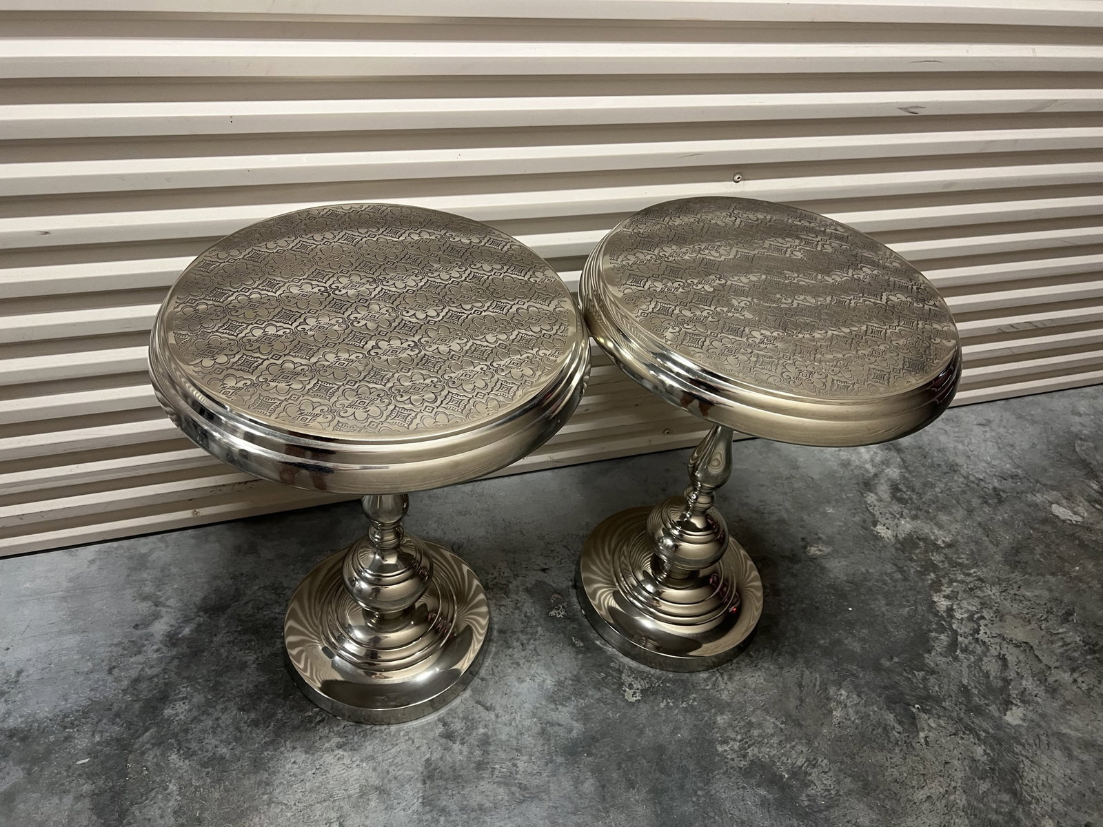 (2) Silver Metal Moroccan Style Side Tables: Metal side tables, unscrew to make shipping and storage easier. Dimensions: H 24" x Dia: 18" Condition: Lightly used, presenting well. Low Estimate: 10.00 High Estimate: 10000.00