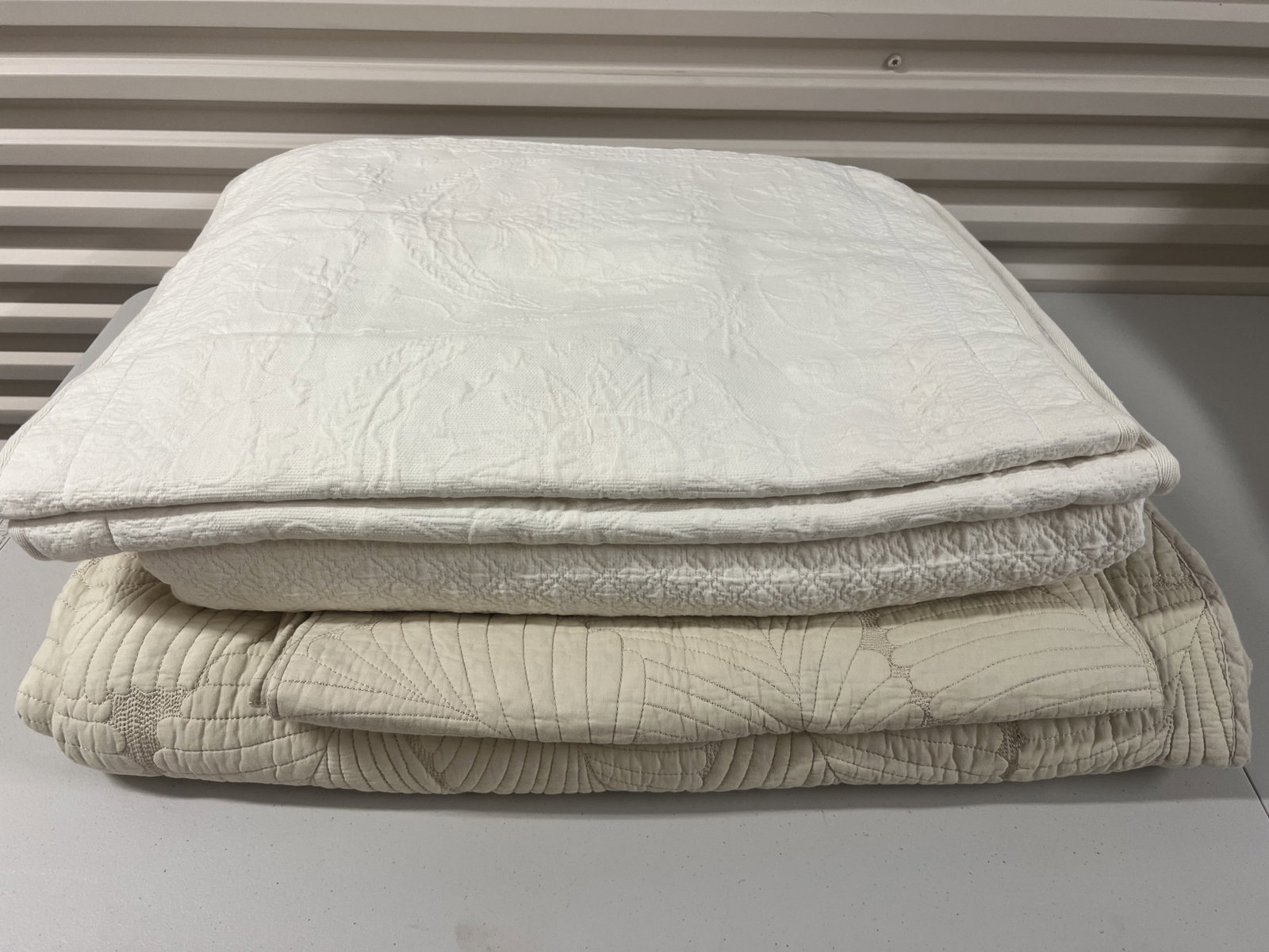 (2) King Size Cotton Quilted Coverlettes: White and Cream both in lightly used condition. Low Estimate: 10.00 High Estimate: 10000.00