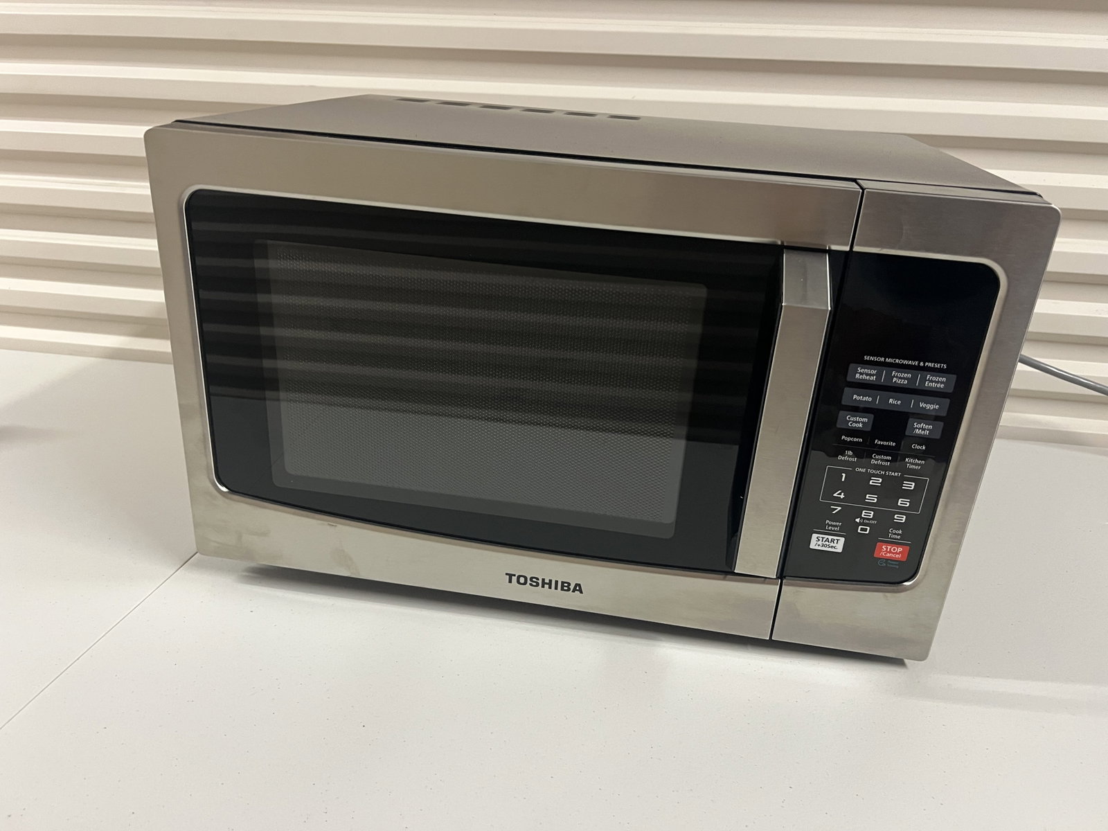 Toshiba Stainless Steel Microwave: Dimensions: L 20.5" x H 12.5" x D 14.5" Condition: Lightly used, clean. Missing one rubber foot under. Low Estimate: 10.00 High Estimate: 10000.00