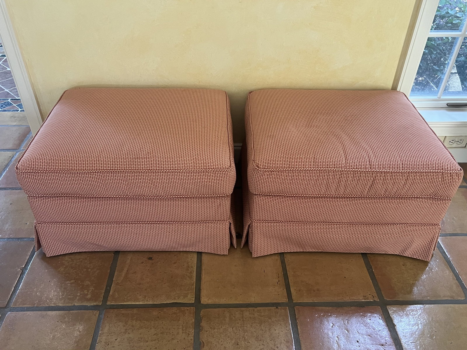 Pair of Ottomans: Rolling ottomans, rectangular shape, red gingham pattern, skirted. Comfy, rolling nicely. L 27" x W23" x H 16" Condition: Some light stains to upholstery. Low Estimate: 10.00 High Estimate: 10000.00
