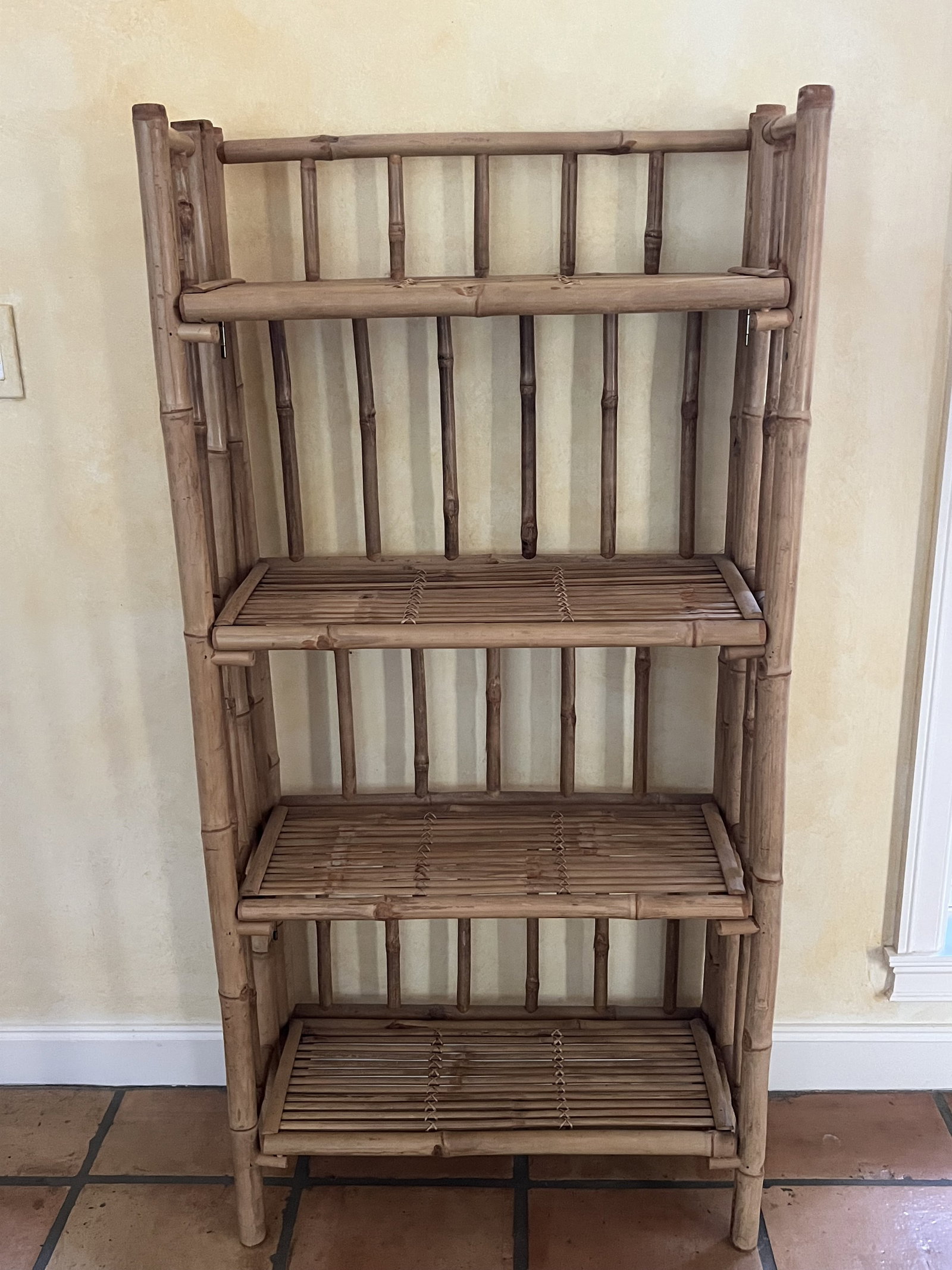 Folding Bamboo Bookshelf: A folding book shelf made totally out of bamboo. Dimensions: H 53" x W 26" x D 11.5" Condition: Presenting well, folding nicely, vintage patina. Low Estimate: 10.00 High Estimate: 10000.00