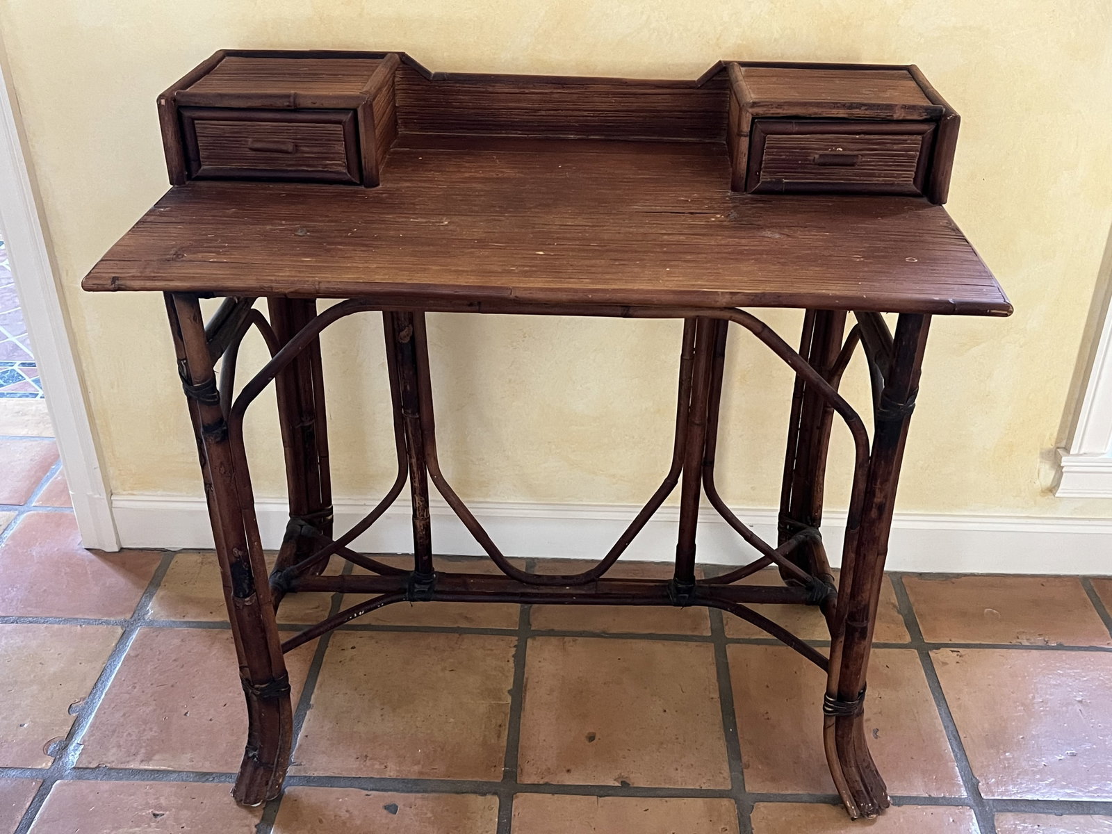 Vintage Bamboo Desk: Two drawers, curved legs, vintage. Dimensions: H 34" x W 35" x D 19.5" Condition: Some signs of age and use. Low Estimate: 10.00 High Estimate: 10000.00