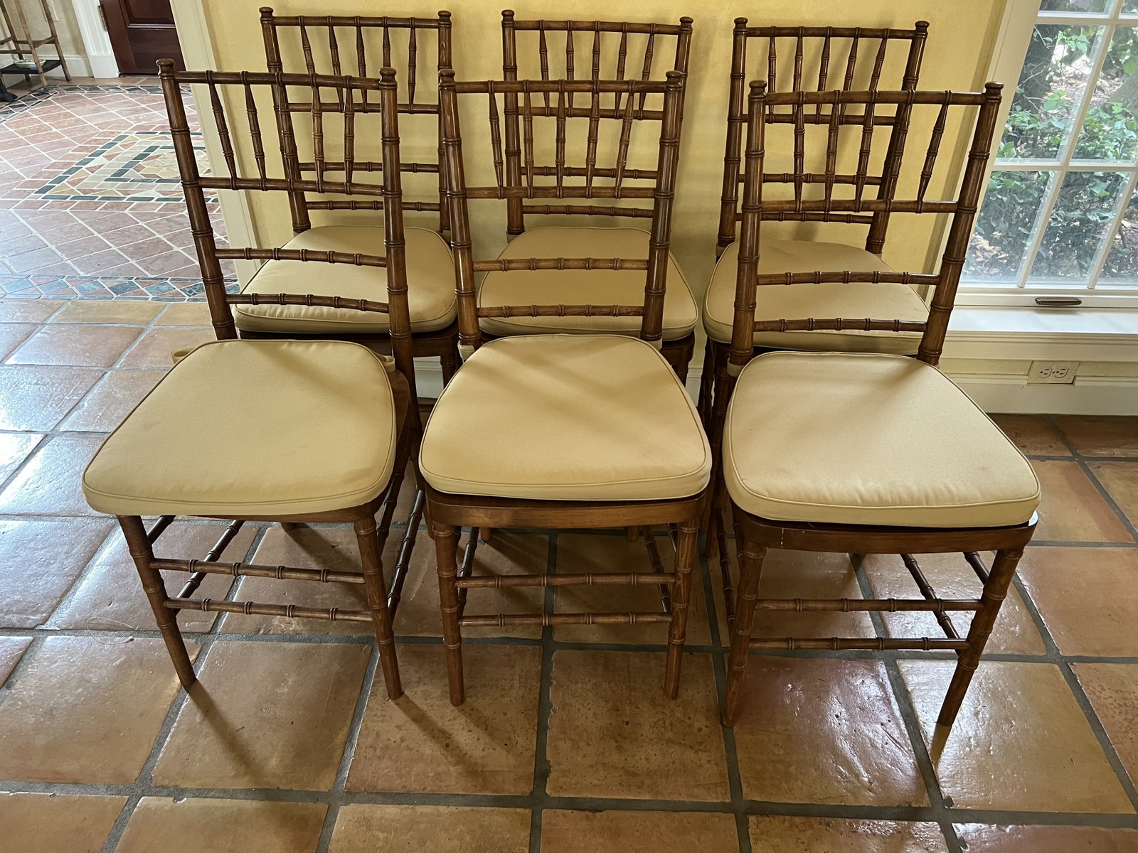 (6) Faux Bamboo Dining Chairs: Contemporary Chiavari chairs, solid wood with cushions. Dimensions: H 36" x W 15" x D 15" x Seat Height: 18" Condition: Cushions with some staining. Low Estimate: 10.00 High Estimate: 10000.00