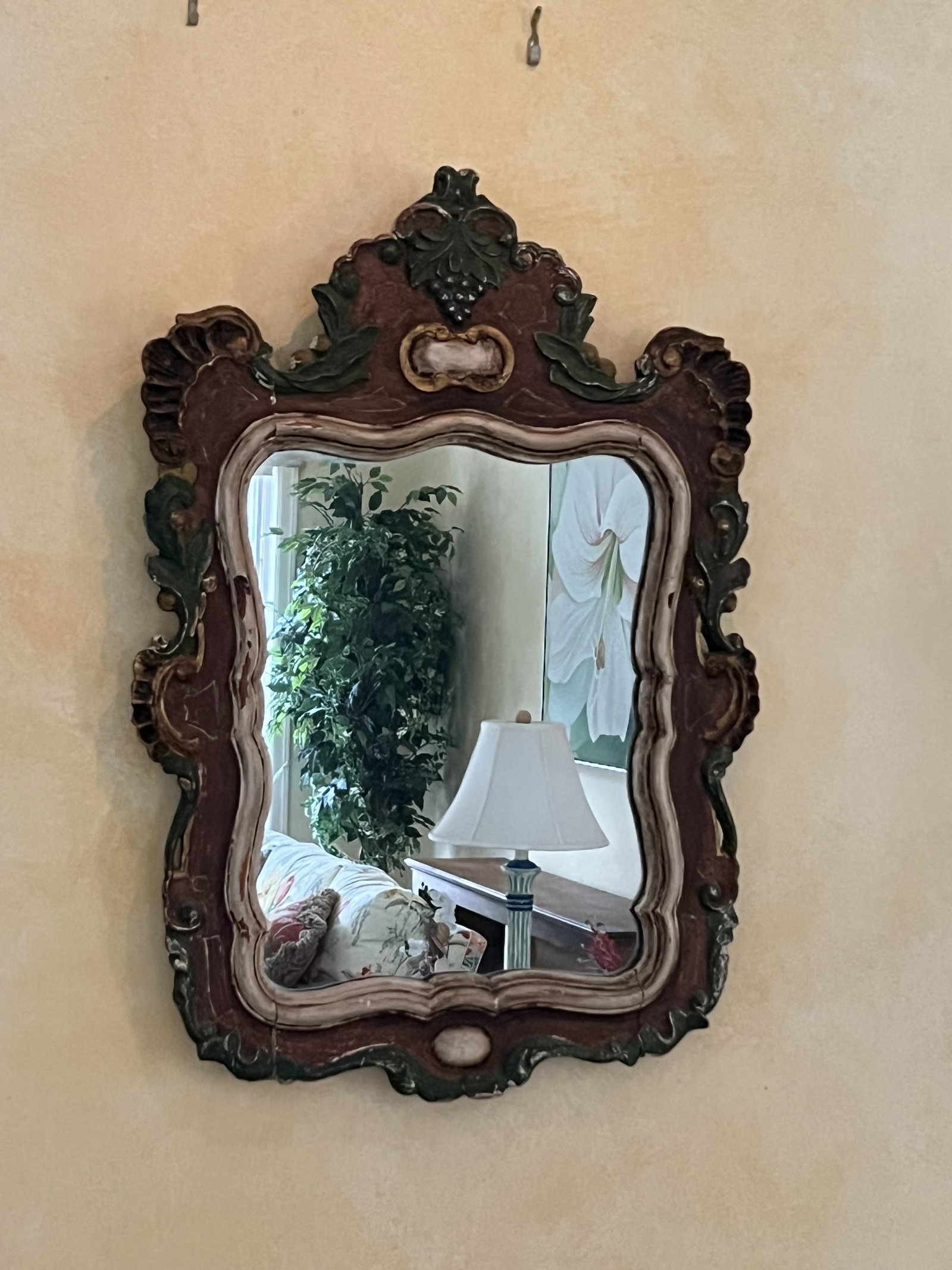 Antique Carved Wood Italian Style Mirror: Shell corners with gold leafing fruit & grape leaves foliage. Shabby chic paint. Showing size of age. H 31" x W 21.5" Presenting well Low Estimate: 10.00 High Estimate: 10000.00