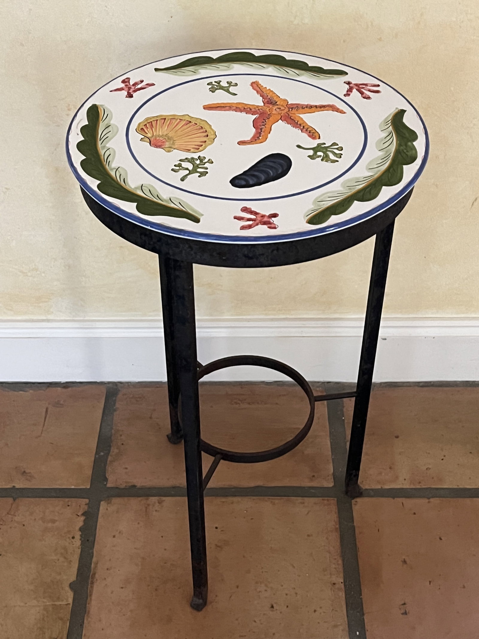 Majilly by L'Antica Deruta Italy Shell side table: Iron base side table. terra cotta signed top. shell design. H 21" x W 12" diameter. nice condition Low Estimate: 10.00 High Estimate: 10000.00