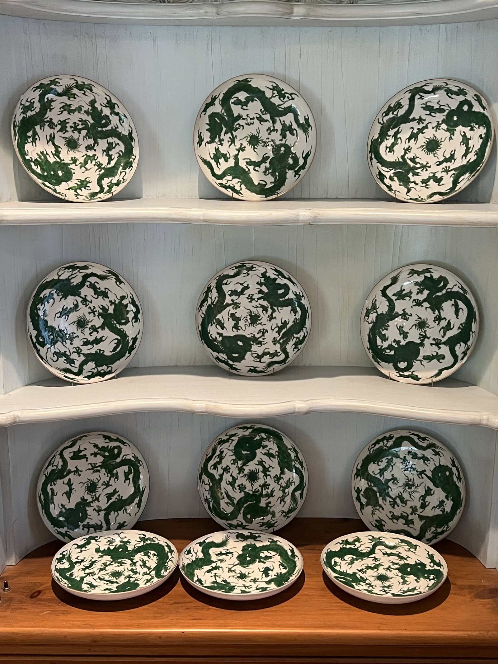 12 Green & White Chinese Dragon Plates: (12) 8.5" diameter 1" deep plates with green dragon motif, signed on bottom, chinese export, one plate has 3 large chips, 1 plate small edge chip, minor losses to paint, one plate with stress