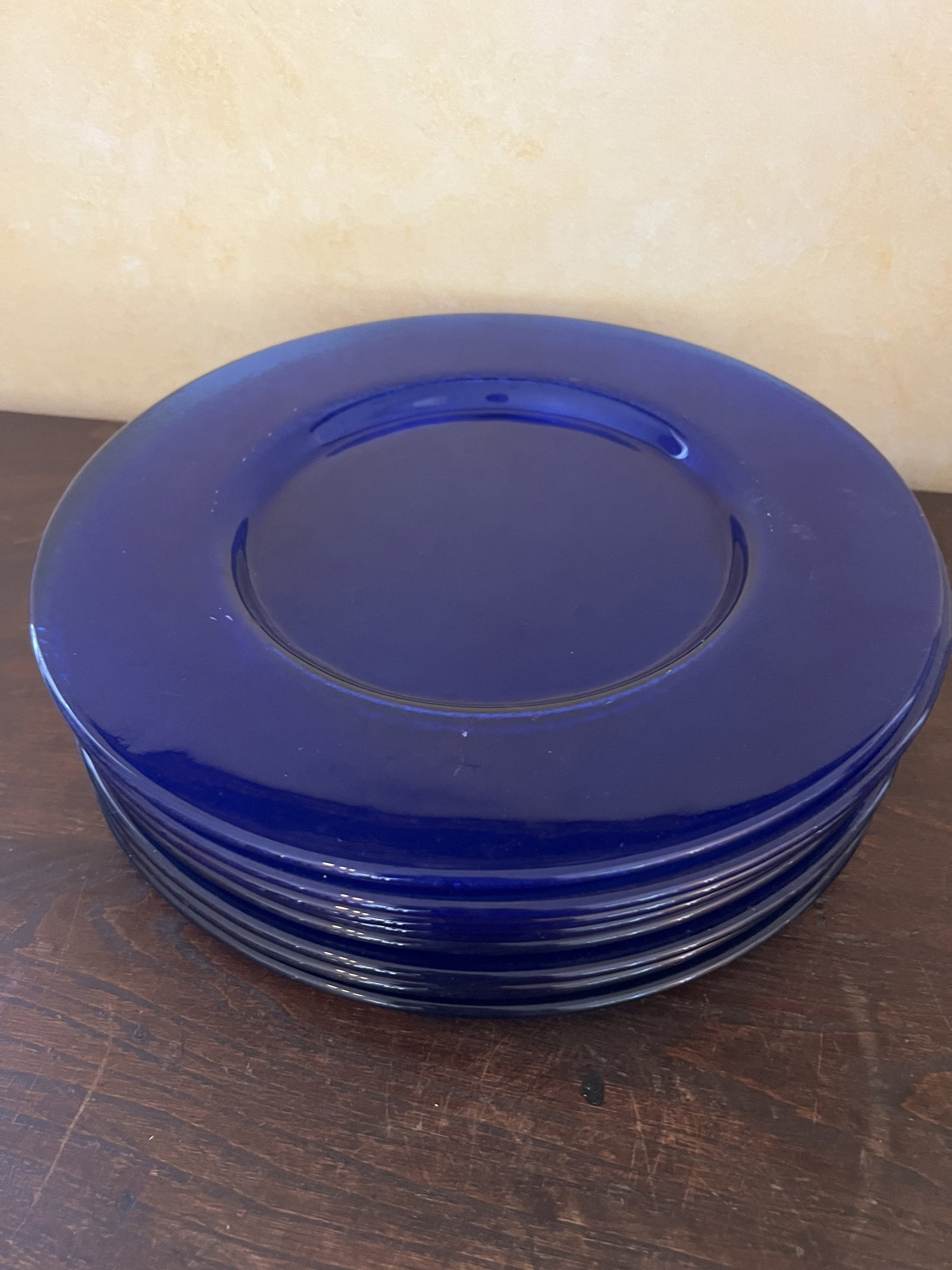 (8) Italian Blue Glass Chargers: Cobalt blue glass chargers measuring 13.25" diameter. Condition: Lightly used. Low Estimate: 10.00 High Estimate: 10000.00