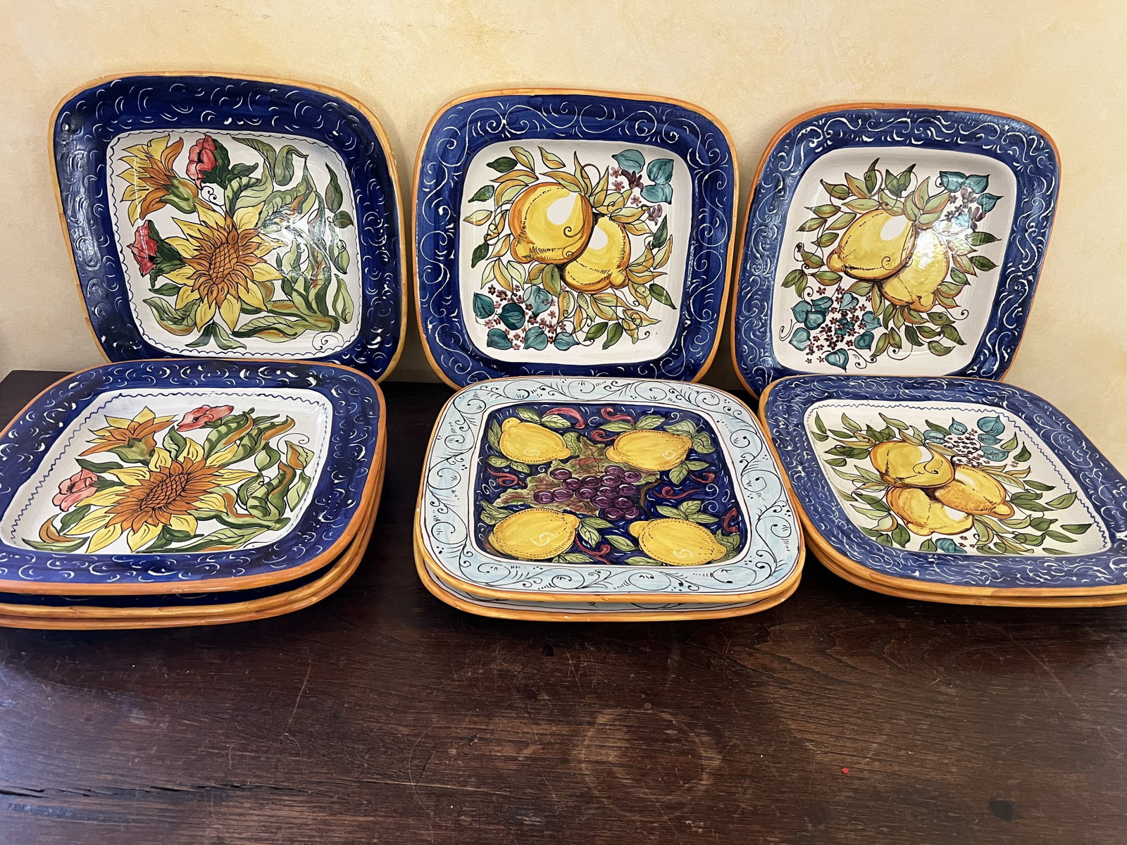 (10) Italian Hand Painted Square Plates: Signed Elsarte on back. With themes of lemons and flowers, ready to hang. Dimensions: 11" Condition: Presenting well, no issue to note. Low Estimate: 10.00 High Estimate: 10000.00