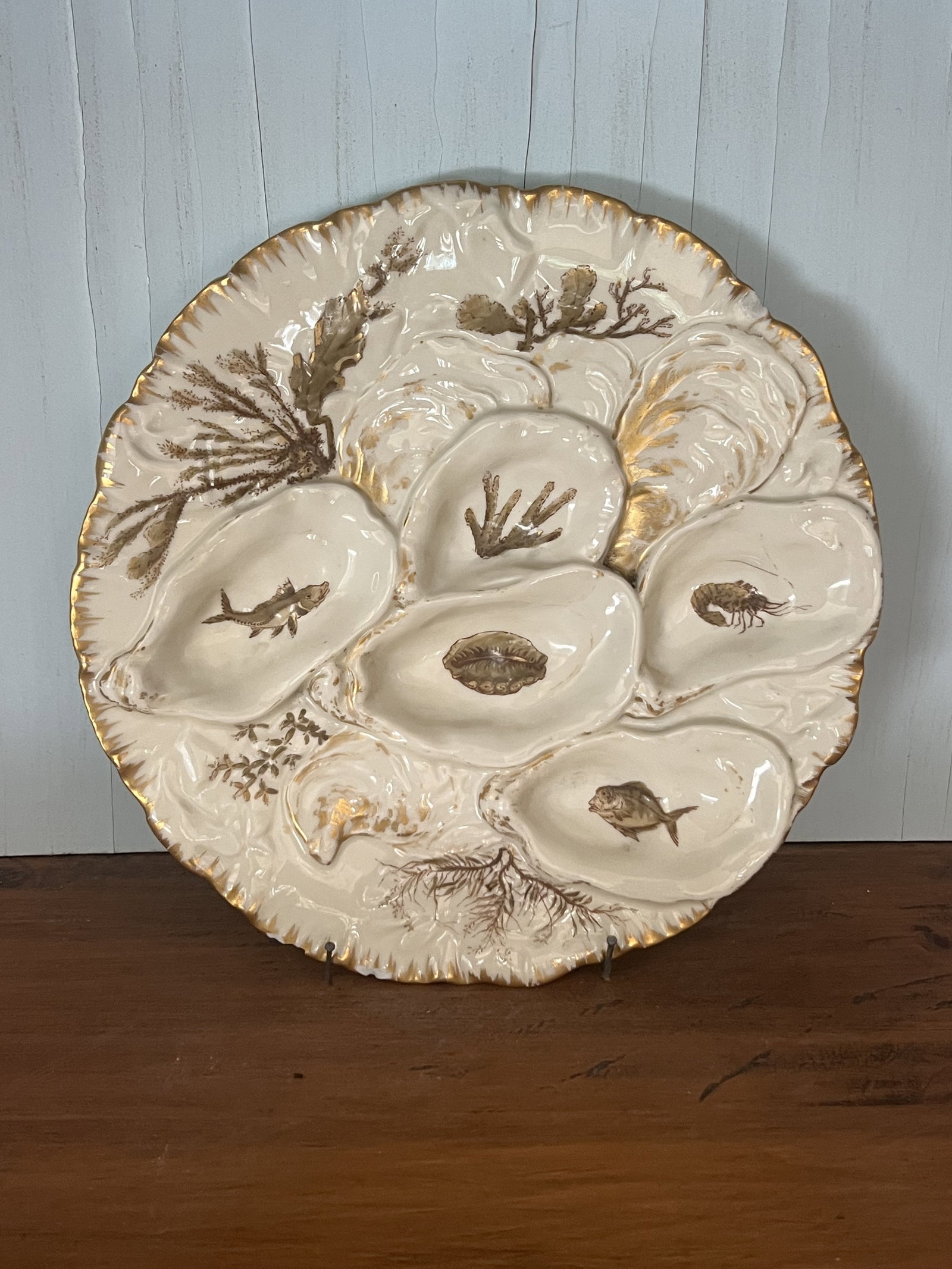 Haviland Limoges Oyster Plate: Antique oyster plate in cream color with gold accents. Dimensions: almost 9" Condition: Nice, very light signs of age. Low Estimate: 10.00 High Estimate: 10000.00