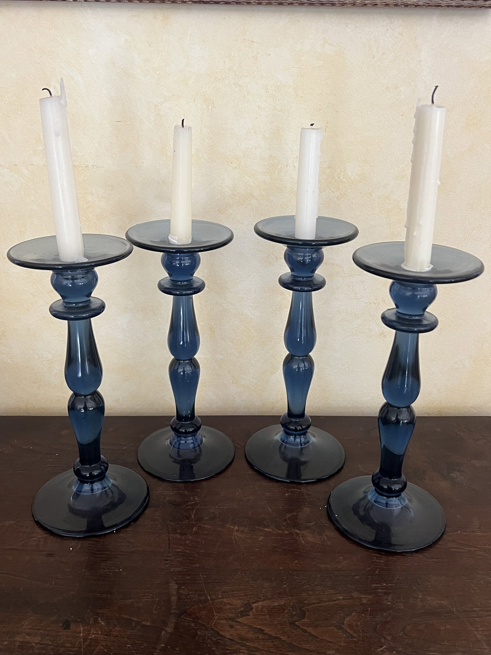 (4) Blue Glass Candlesticks: Blue pressed glass candlesticks, maker unknown. Dimensions: H 11" x Dia: 4.5" Condition: Presenting well, used, Low Estimate: 10.00 High Estimate: 10000.00