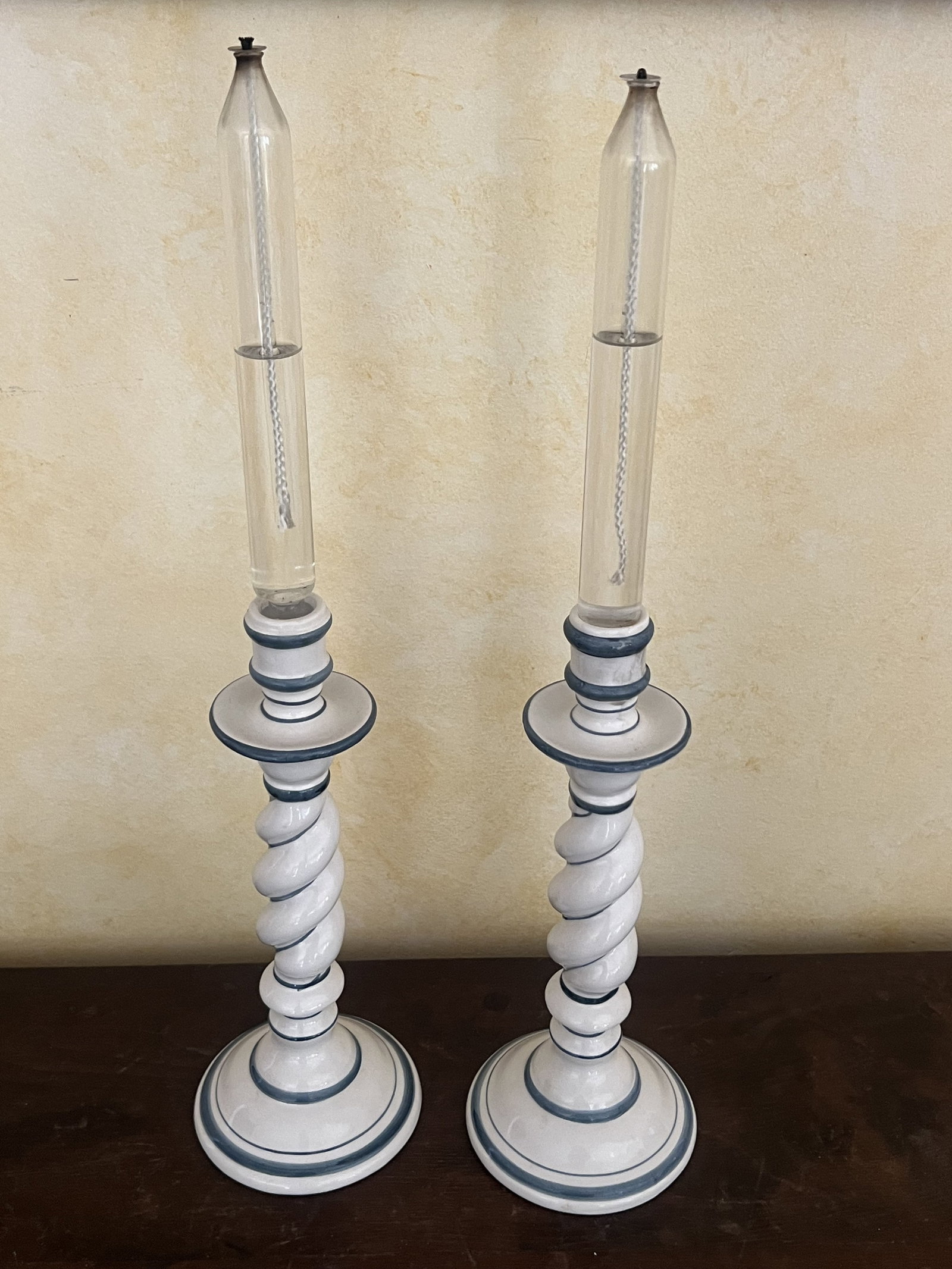 Pair of Blue and White Candlesticks with Oil Lantern Candles: OGG Italy, vintage candlesticks, oil candles cannot be shipped. Dimensions: H 11" x Dia: 5" Condition: Used, no issues to note. Low Estimate: 10.00 High Estimate: 10000.00